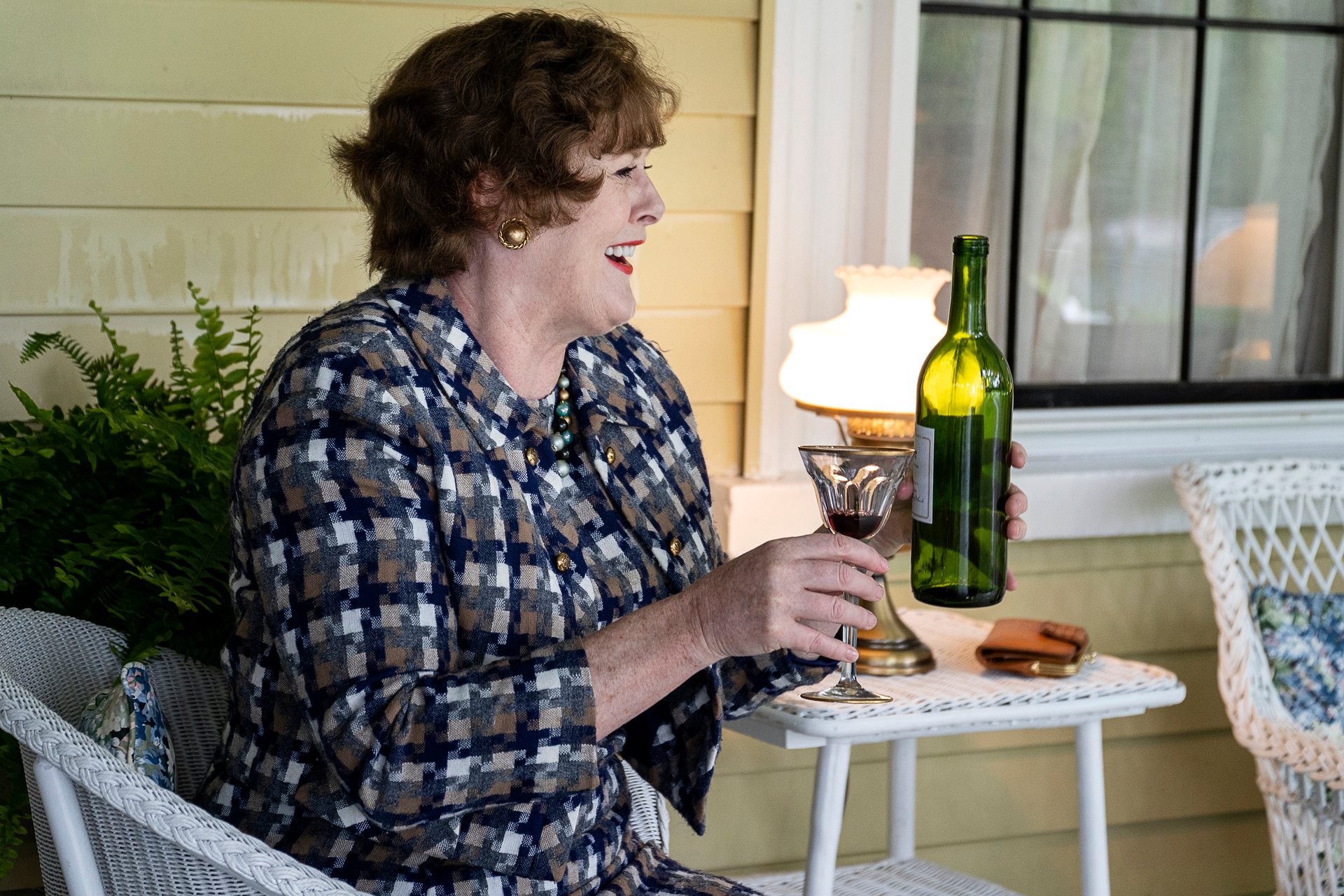 Sarah Lancashire as Julia Child sits on a patio with a drink during an episode of HBO Max's 'Julia' 