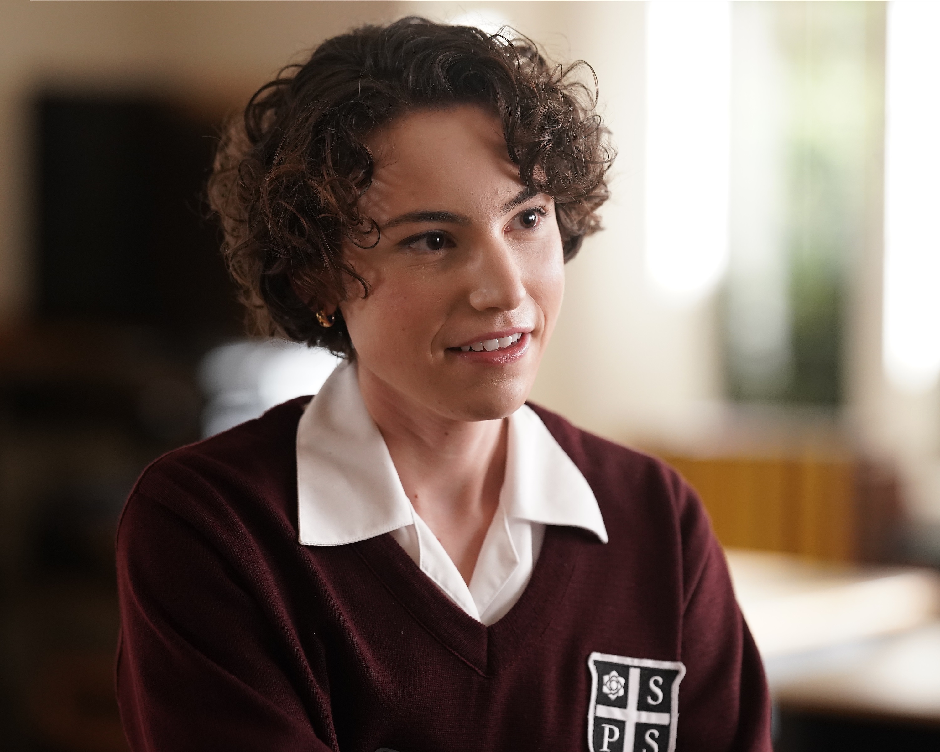 'A Million Little Things' guest star Ash Spencer as Madison/Maddox smiling in her Sussex Prep uniform