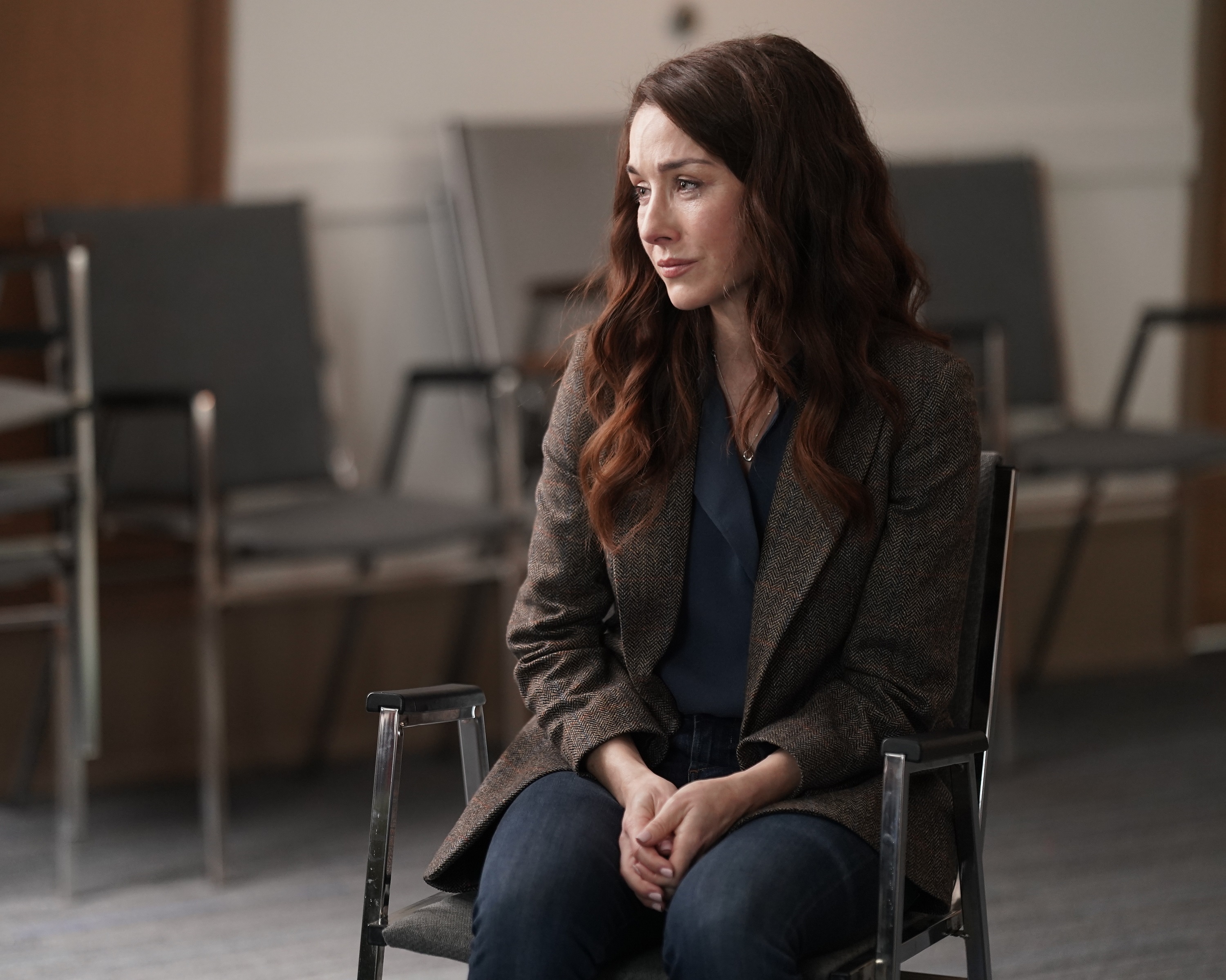 'A Million Little Things' Erin Karpluk as Anna Benoit sitting in a chair with a sad look on her face