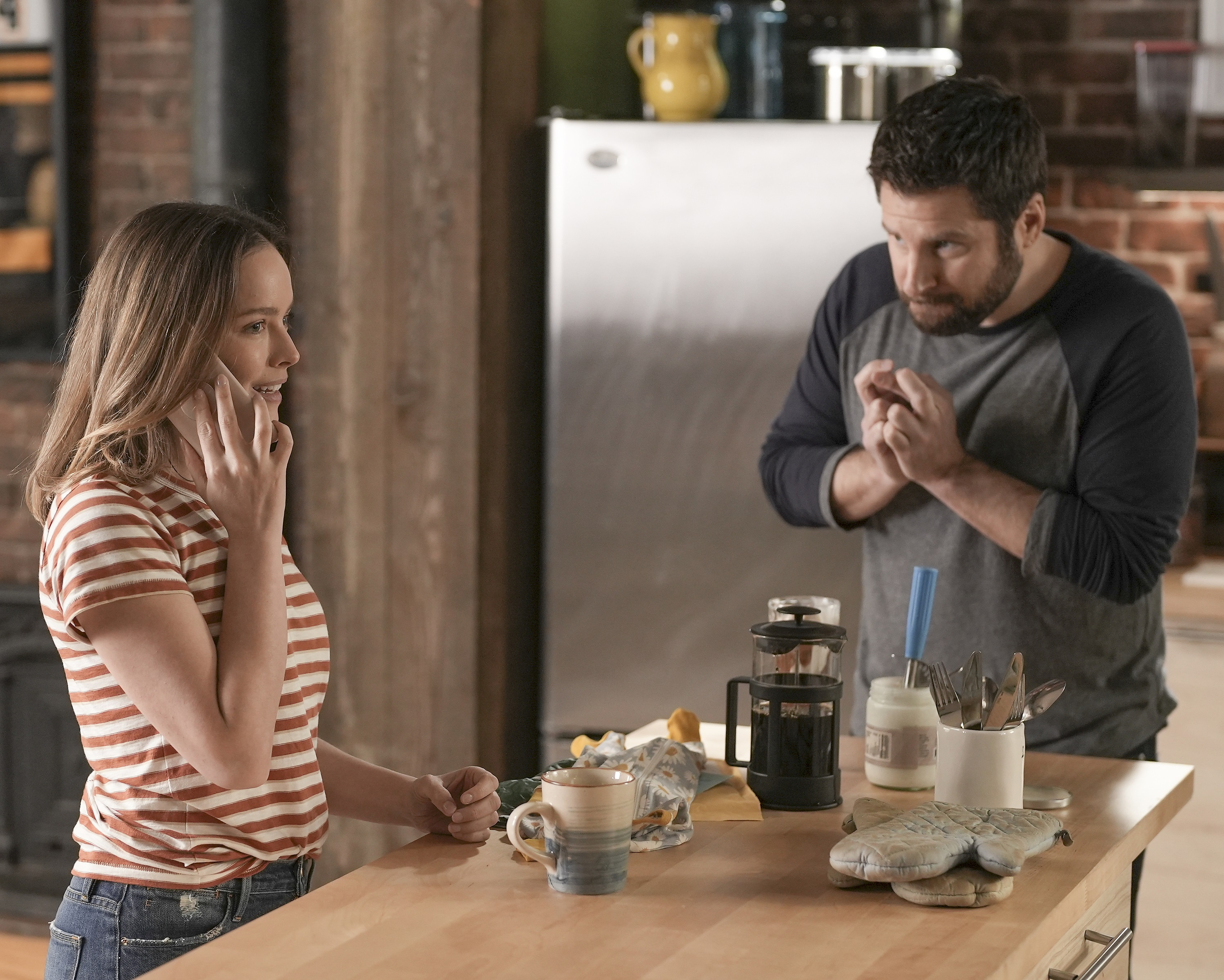 'A Million Little Things' cast member Allison Miller on the phone and James Roday Rodriguez crossing his fingers