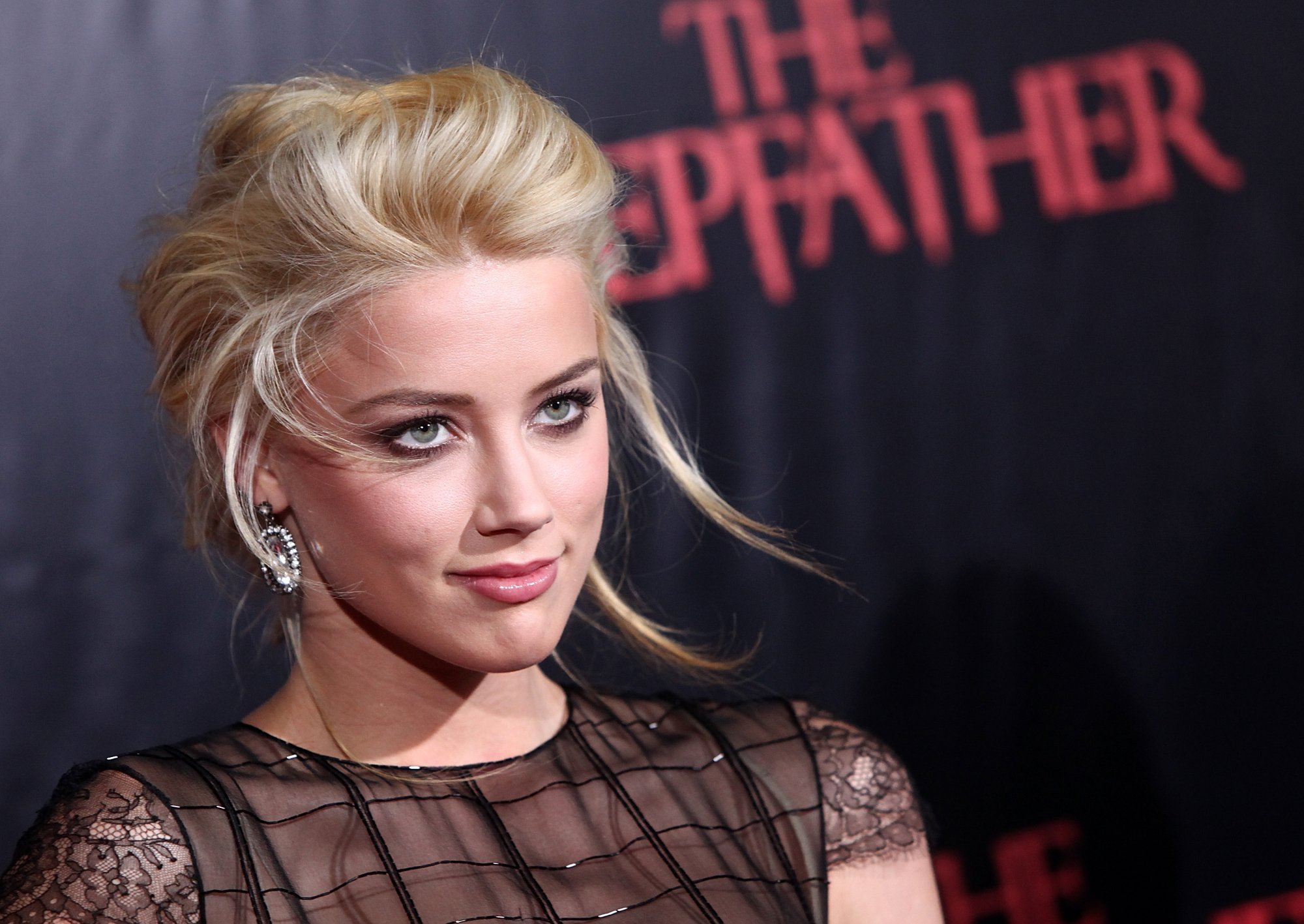 'All the Boys Love Mandy Lane' actor Amber Heard, who Johnny Depp had to teach 'stillness' to for 'The Rum Diary' wearing a black dress in front of 'The Stepfather' step and repeat