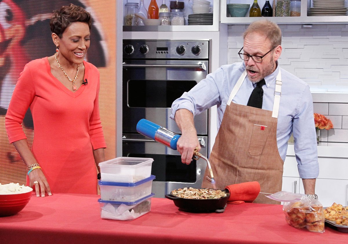 Culinary personality Alton Brown, right, with 'GMA' host Robin Roberts, demonstrates a recipe using a cast-iron skillet.