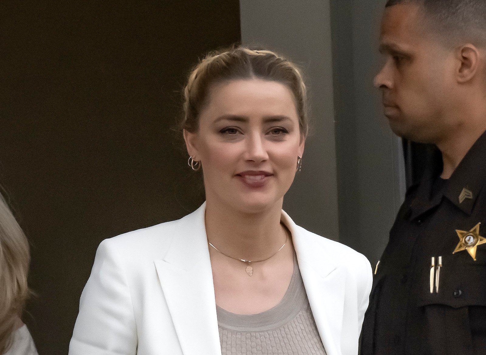 Amber Heard leaves court and smiles for fans 