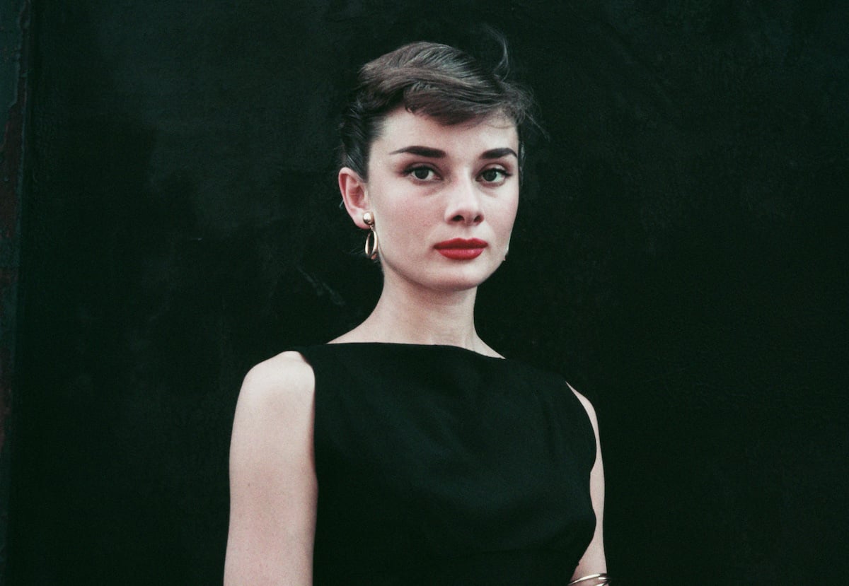 Audrey Hepburn in front of a black background
