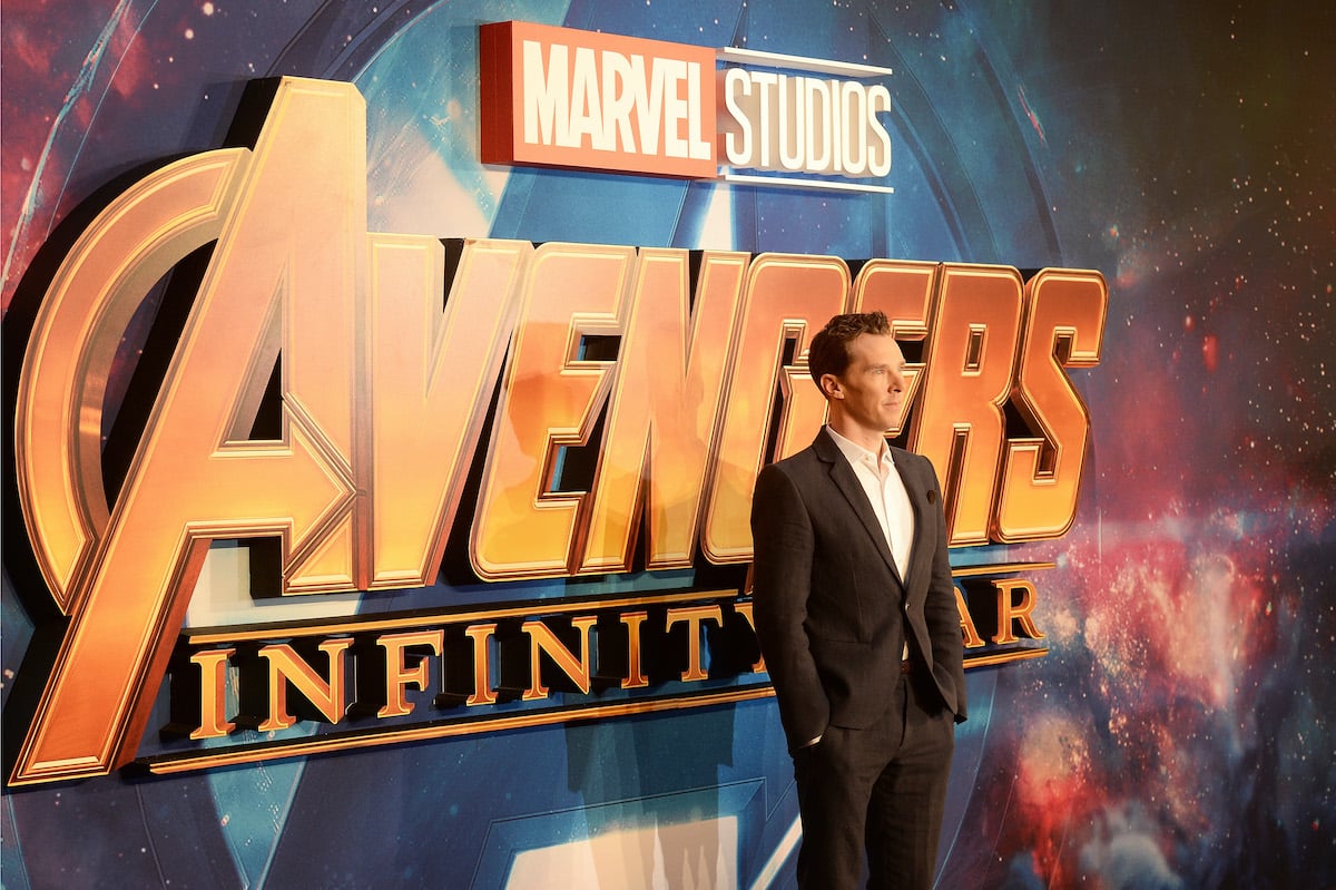 ‘Avengers: Infinity War’ star Benedict Cumberbatch wears a suit and poses in front of the film’s logo