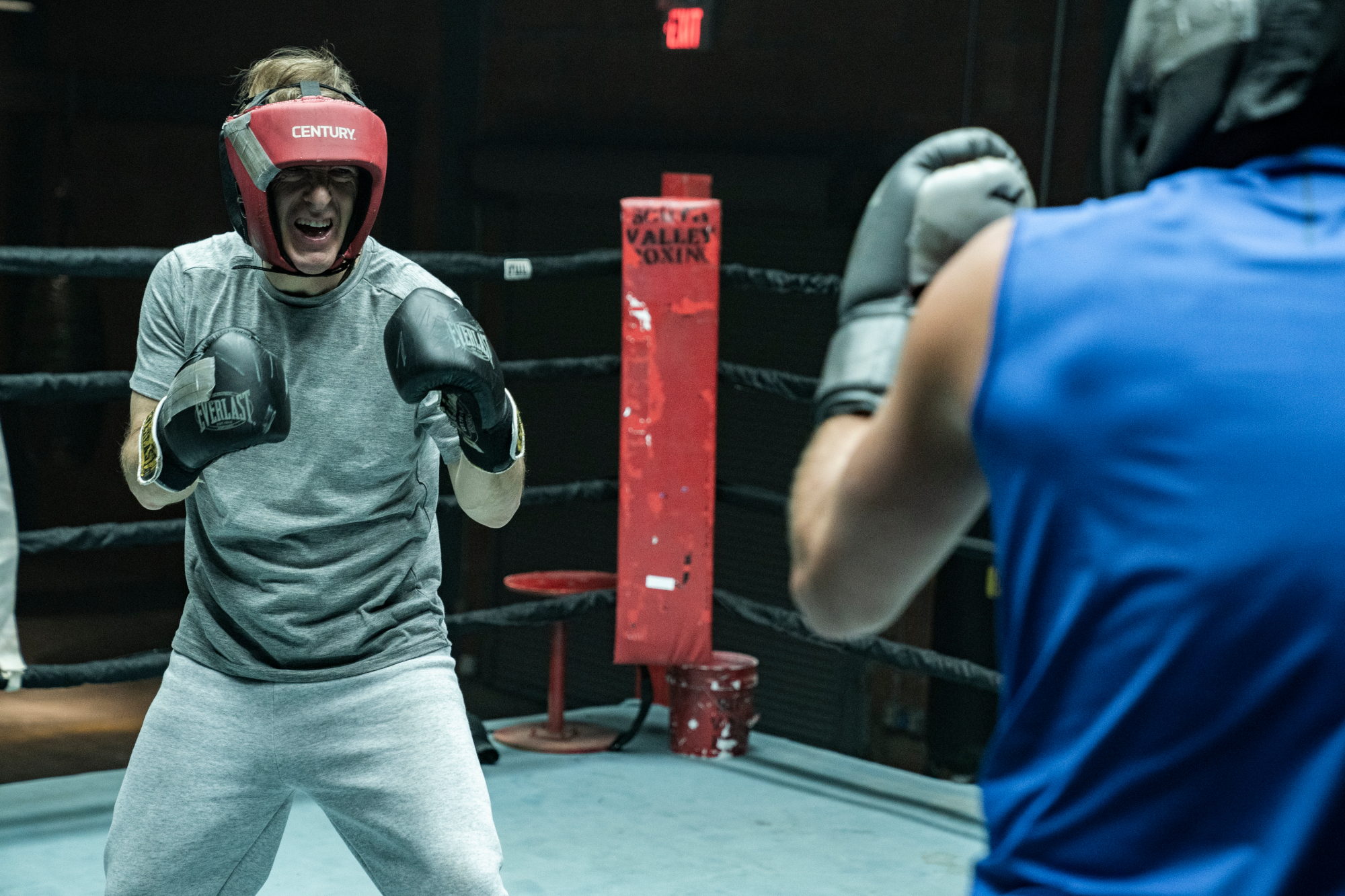 Bob Odenkirk and Patrick Fabian as Jimmy McGill and Howard Hamlin in 'Better Call Saul' Season 6's boxing scene. Howard is wearing a blue shirt and has his back to the camera, and Jimmy is holding up his fists, ready to fight.