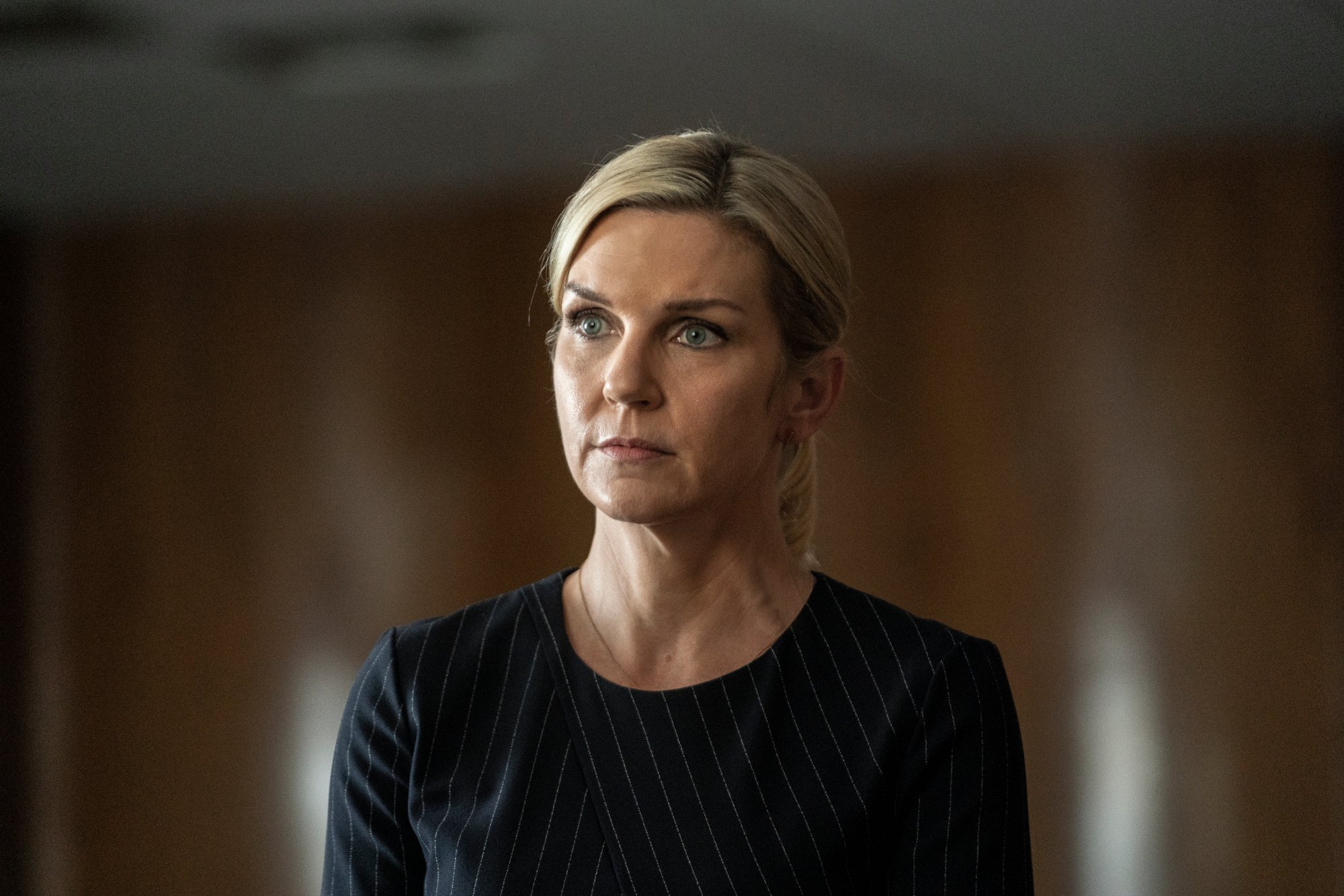 Rhea Seehorn as Kim Wexler in 'Better Call Saul' Season 6 Episode 6. She's in court, her hair is pulled back in a ponytail, and she's wearing a black shirt.