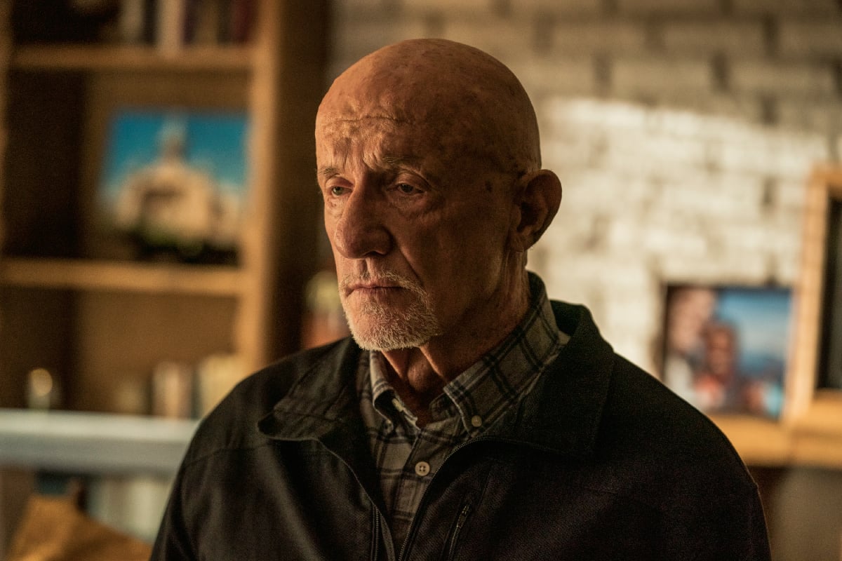 Jonathan Banks as Mike Ehrmantraut in Better Call Saul Season 6. Mike stands in a room with a neutral expression on his face. 