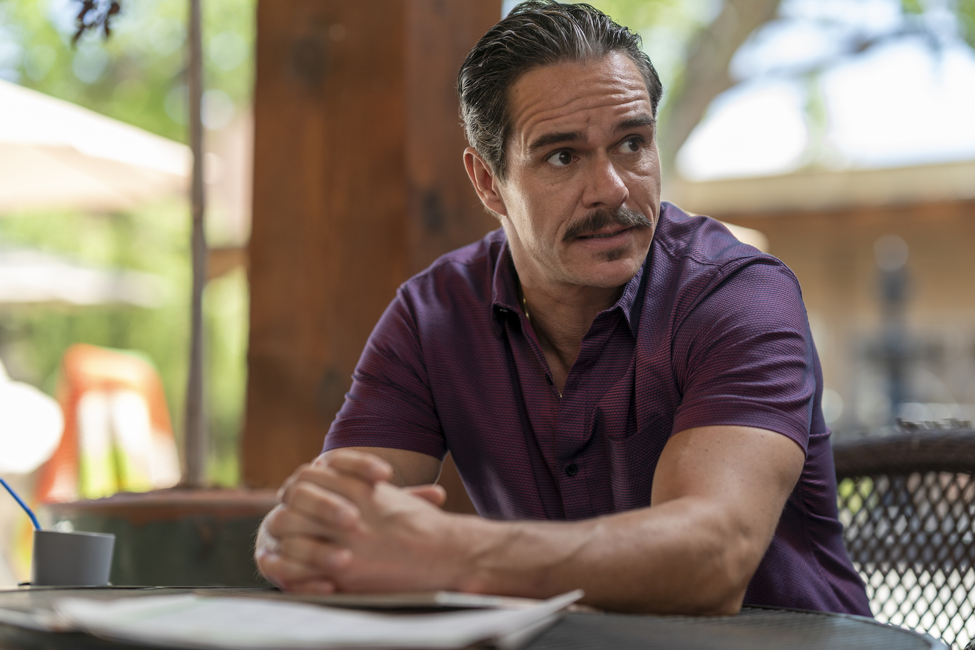 ‘Better Call Saul’ actor Tony Dalton as Lalo Salamanca with a mustache seated and wearing a purple shirt.

