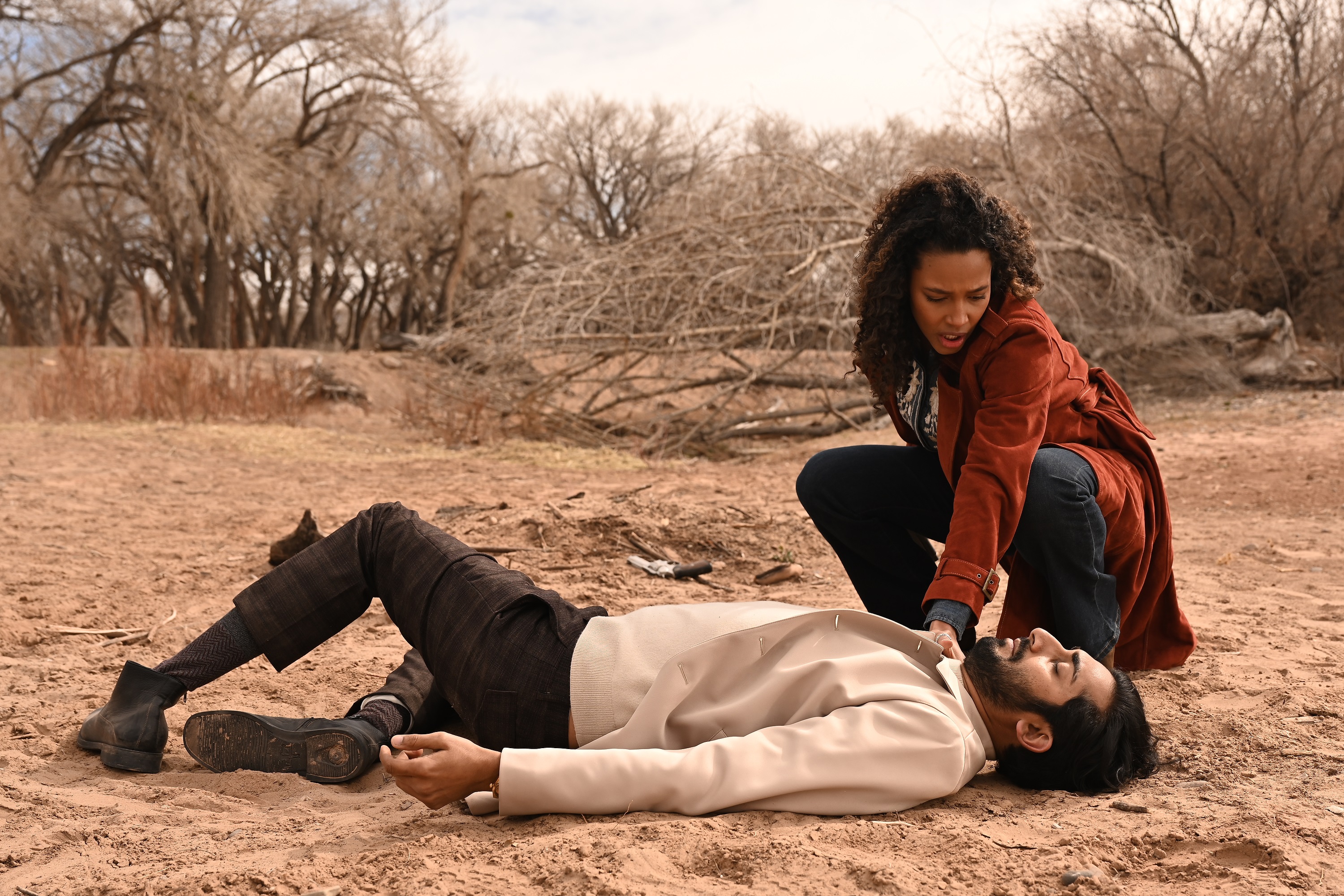 'Big Sky' Season 2 Episode 17 Kylie Bunbury as Cassie Dewell checks for Vinny Chhibber's pulse as he portrays a fallen Jag Buhllar