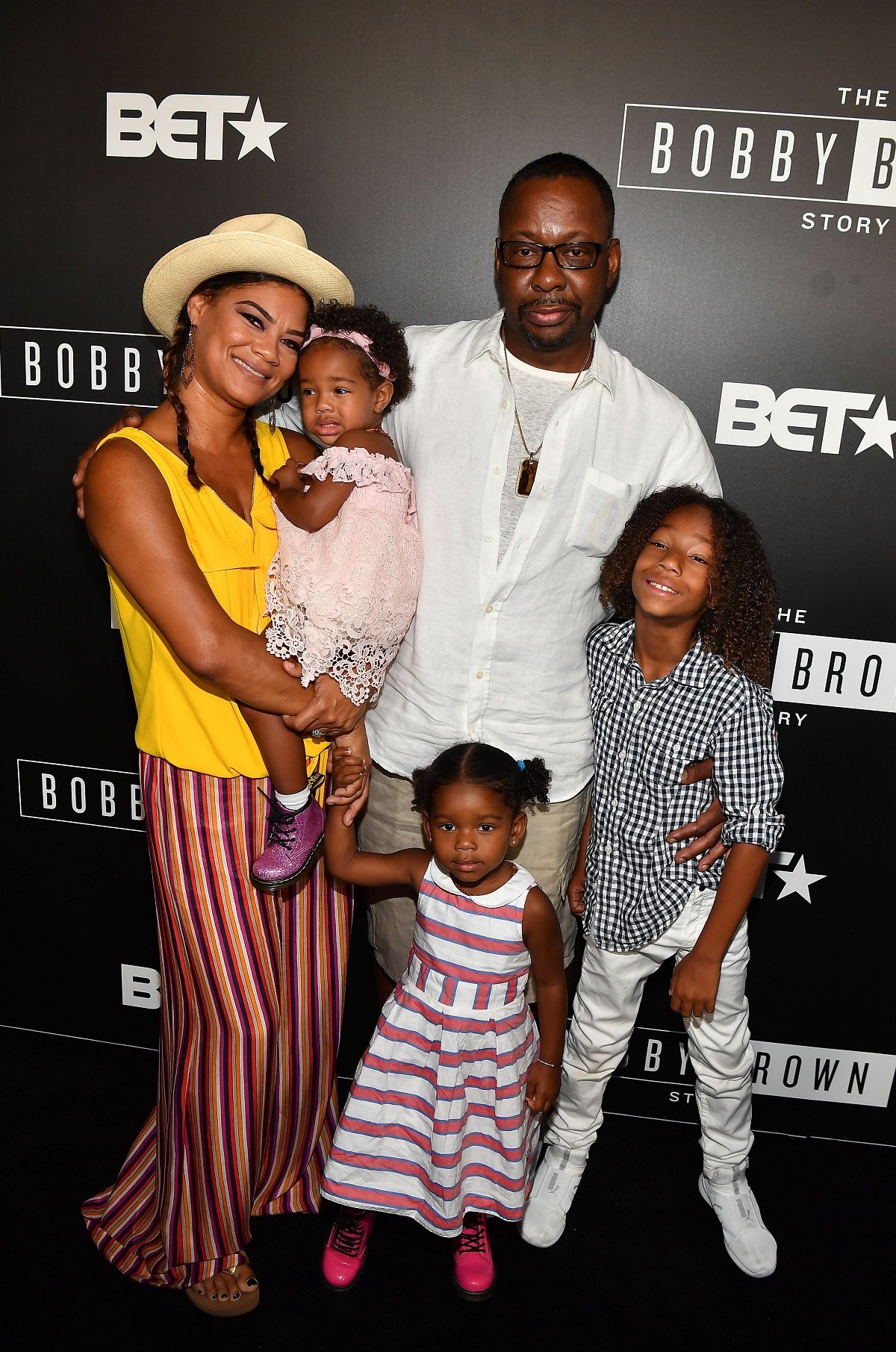 Bobby Brown posing on the red carpet with his wife, Alicia Etheredge-Brown, and their children Bodhi Brown, Hendrix Brown, and Cassius Brown