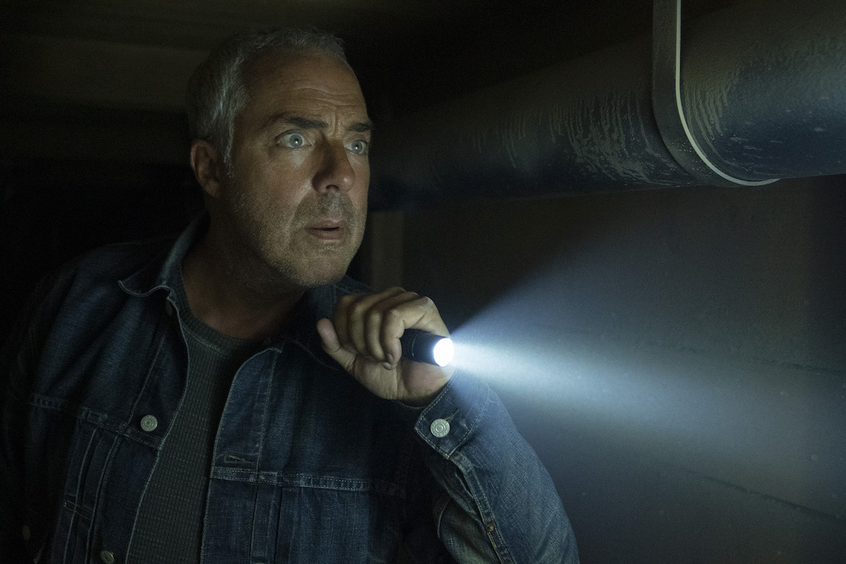 Titus Welliver as Bosch, holding a flashlight, in 'Bosch: Legacy' which will release May 6 on Freevee