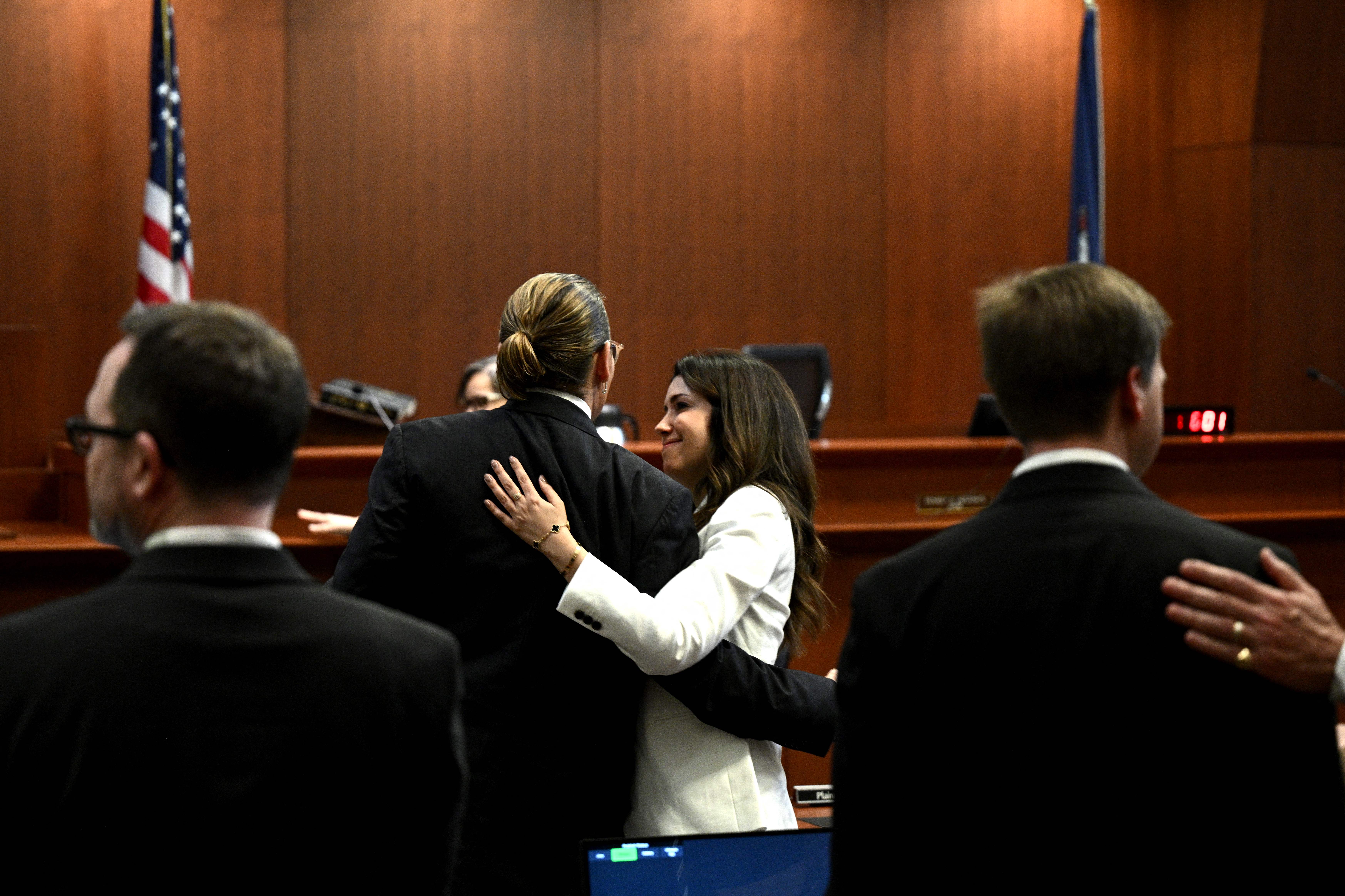 Camille Vasquez and Johnny Depp embrace Johnny Depp in the courtroom at the Fairfax County Circuit Courthouse