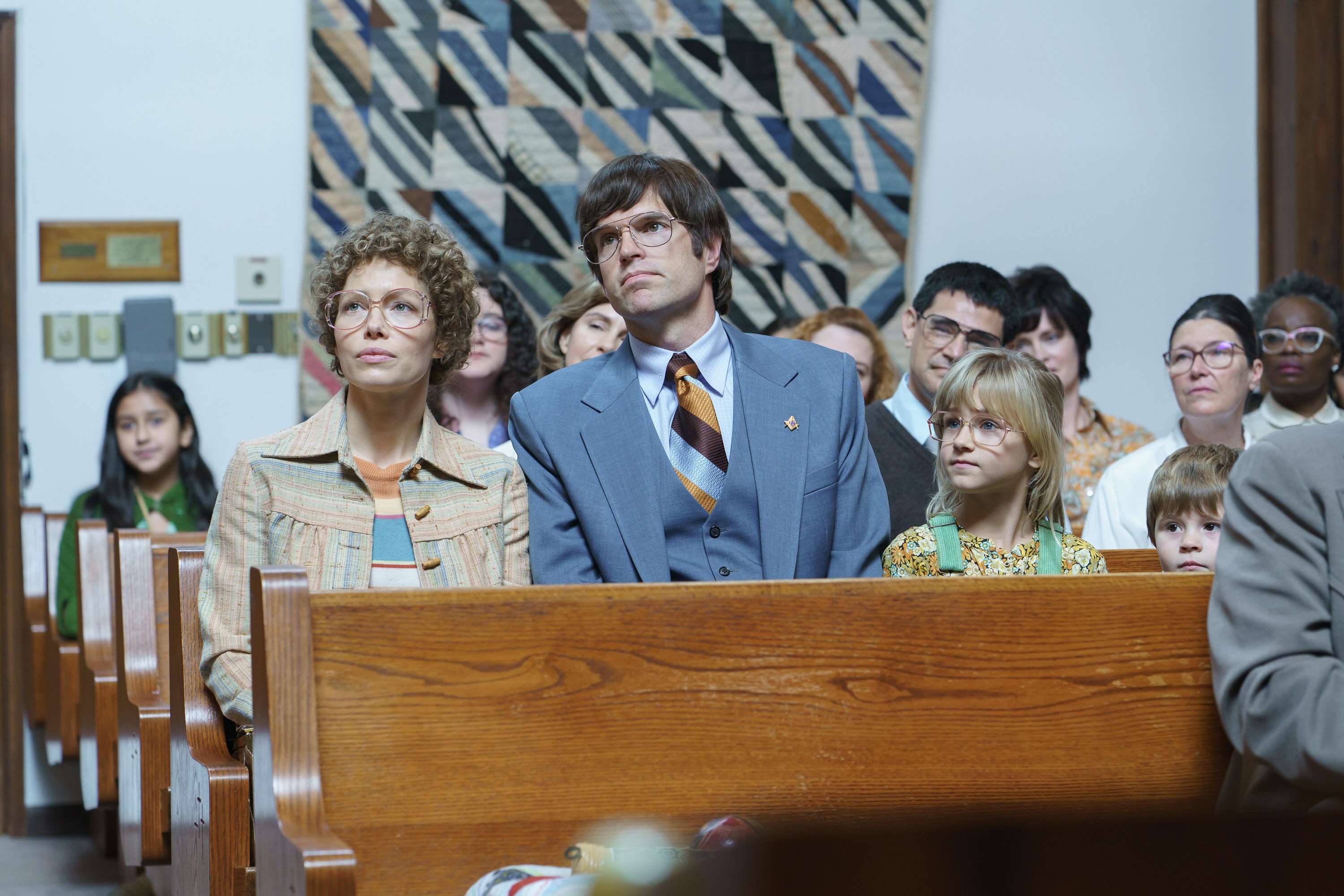 'Candy' on Hulu cast members Jessica Biel and Timothy Simons sitting together in a church pew as Candy and Pat Montgomery