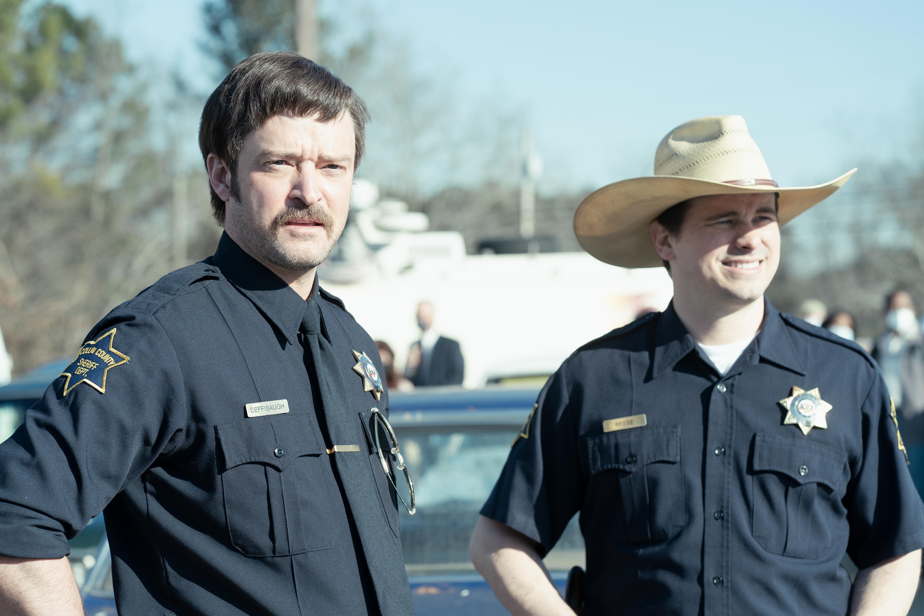 'Candy' cast members Justin Timberlake as Steve Deffibaugh and Jason Ritter as Deputy Denny Reese standing together as cops