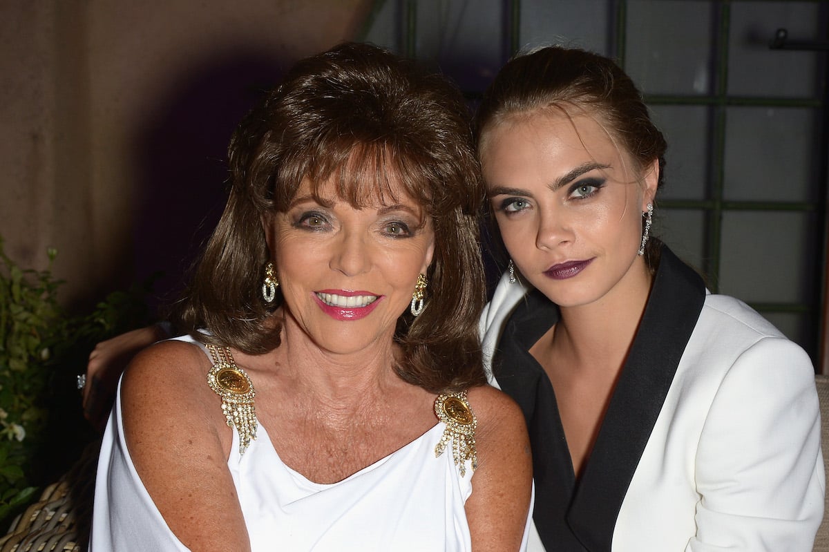 Cara Delevingne and Joan Collins smile for the camera at a 2014 gala