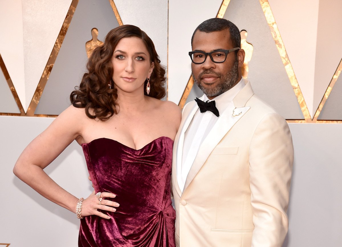 Chelsea Peretti and Jordan Peele pose for photos on the red carpet of the 2018 Oscars