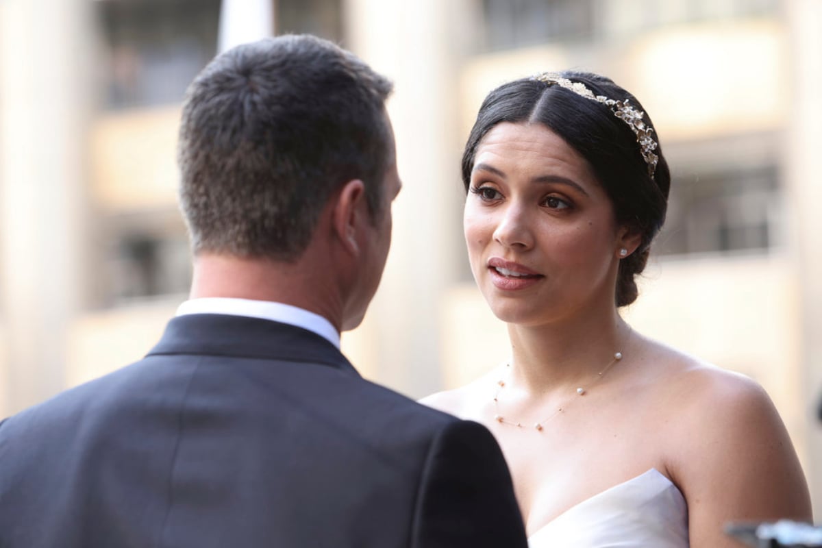 Stella Kidd and Kelly Severide in the Chicago Fire Season 10 finale. Kidd wears a wedding dress and Severide wears a suit.