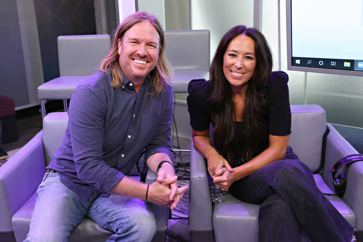 Chip and Joanna Gaines smile while seated together.