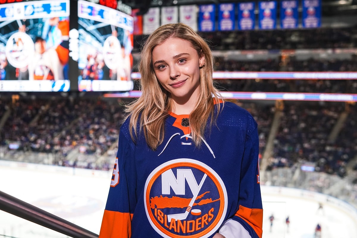 Chloe Grace Moretz smiling while wearing a jersey.