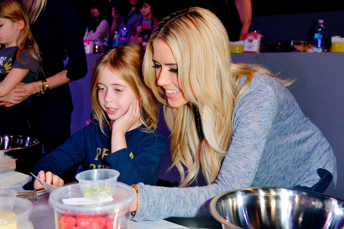 Christina Haack and Christina Haack's daughter Taylor El Moussa sit at a table