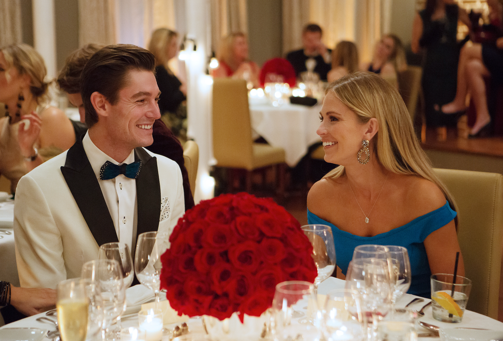 Craig Conover and Cameran Eubanks from 'Southern Charm' smile at each other during dinner at a party