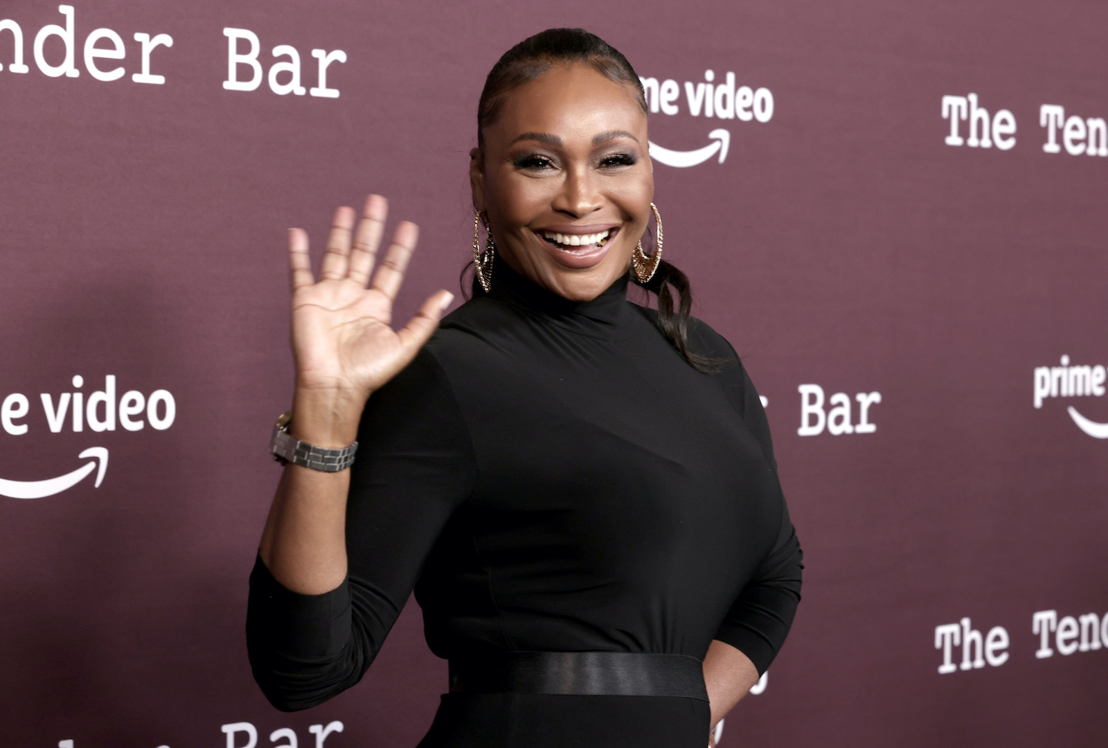 Cynthia Bailey smiles and waves at fans during a movie premiere. 