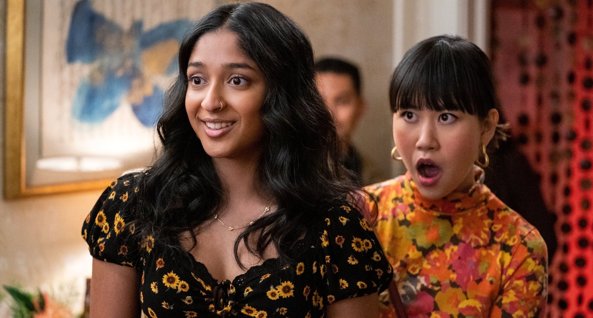 Devi and Eleanor from 'Never Have I Ever' Season 3 gasping and wearing floral dresses.