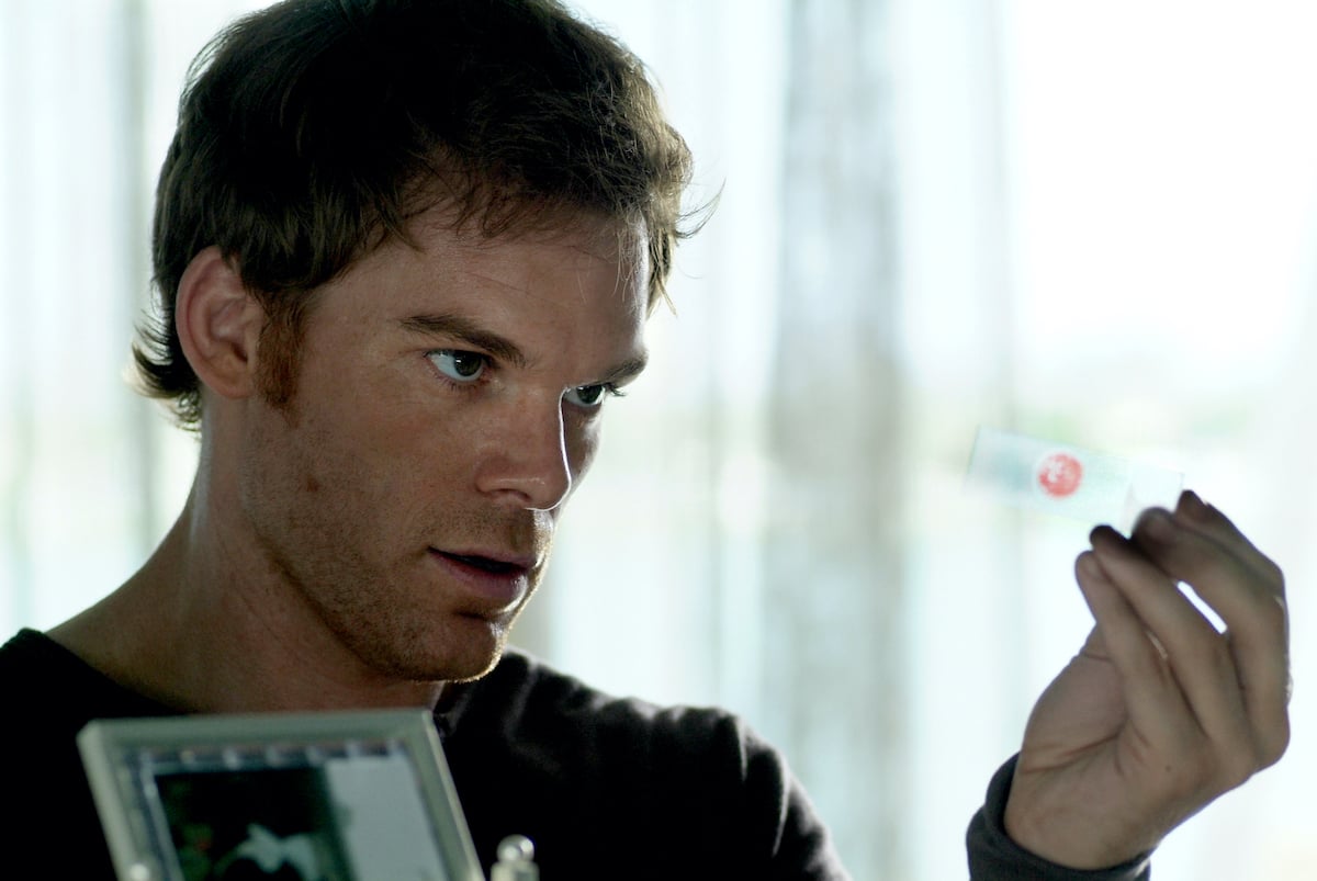 Michael C. Hall as Dexter Morgan looking at a glass microscope slide