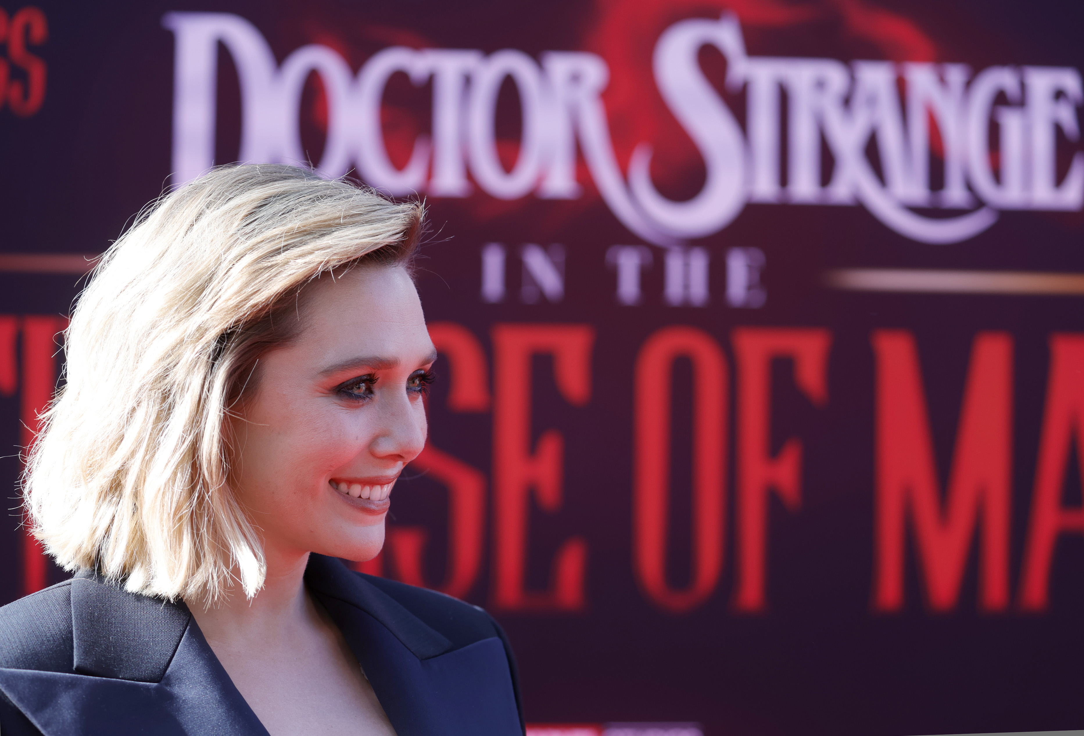 Elizabeth Olsen, star of 'Doctor Strange 2', which isn't on Disney+ yet, wears a black suit jacket.