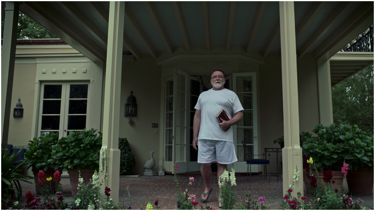 Keith Boyle as Donald Cline in 'Our Father' standing outside his house