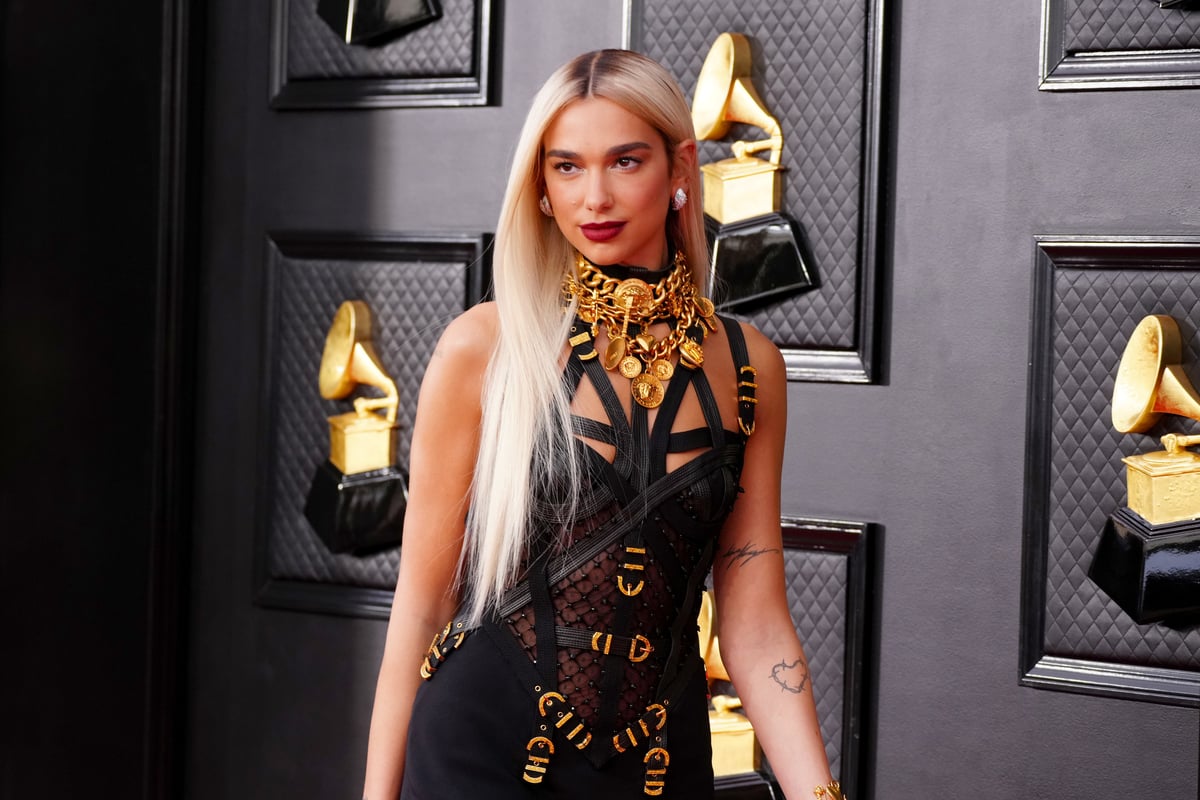 Wearing a black Versace dress, Dua Lipa, who will star opposite Margot Robbie in Barbie, poses on the red carpet of the Grammy Awards in Las Vegas, NV.