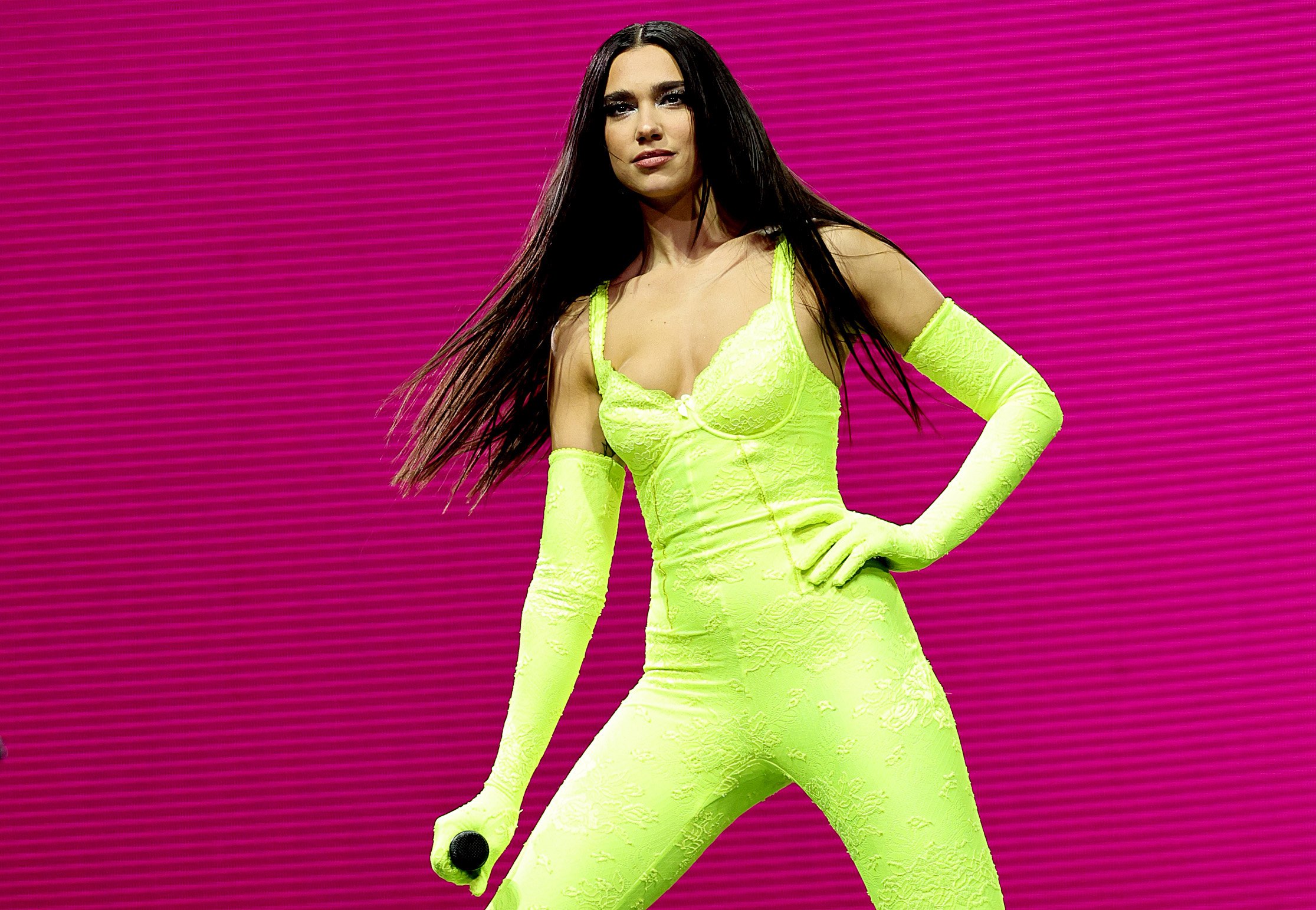 Jack Harlow name a song ‘Dua Lipa’ after the singer, seen here wearing a green outfit while performing on stage.