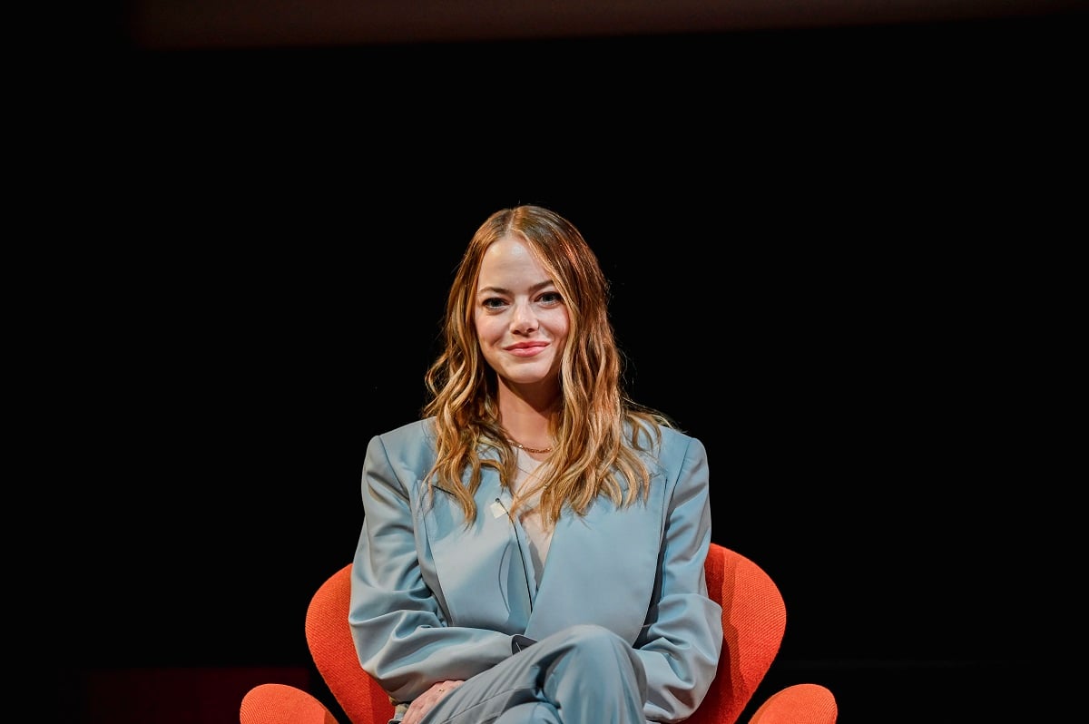 Emma Stone smiling while wearing a blue dress.