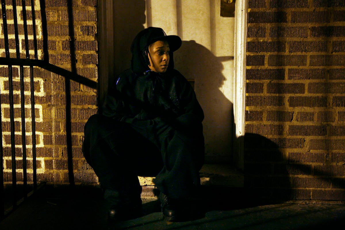 Felicia Pearson sitting on a stoop