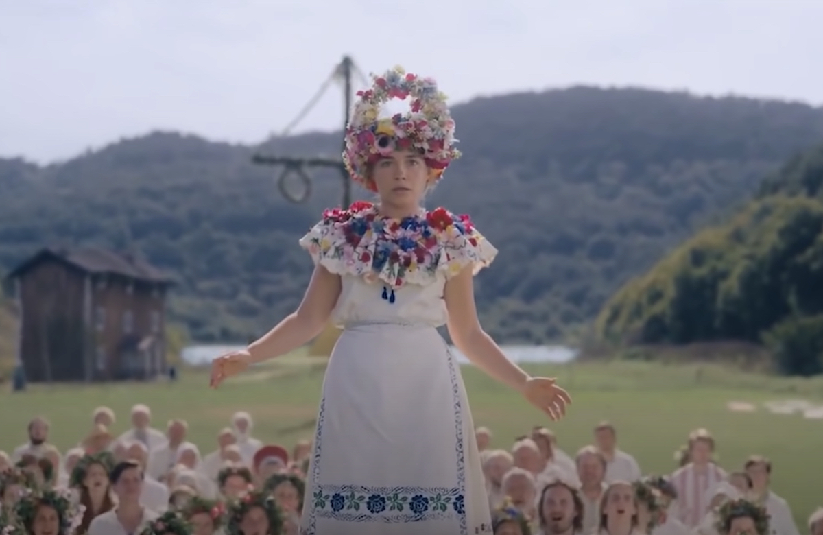 Actress Florence Pugh is raised above the crowd of Swedish festival goers in Midsommar