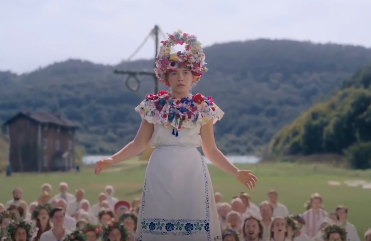 Actress Florence Pugh is raised above the crowd of Swedish festival goers in Midsommar