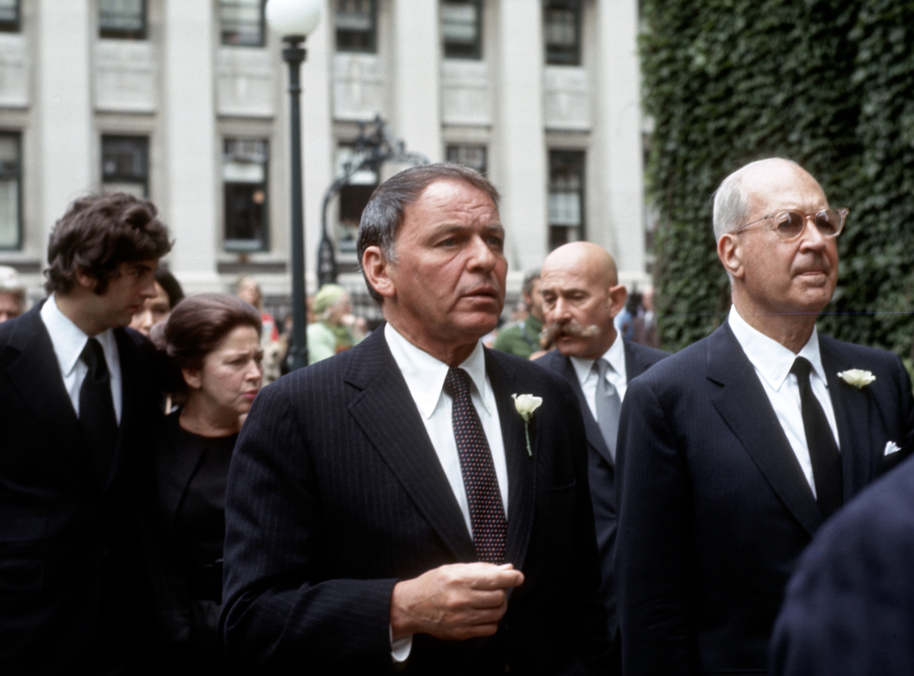 Frank Sinatra wears a suit and walks into a church; his religion was Catholicism.