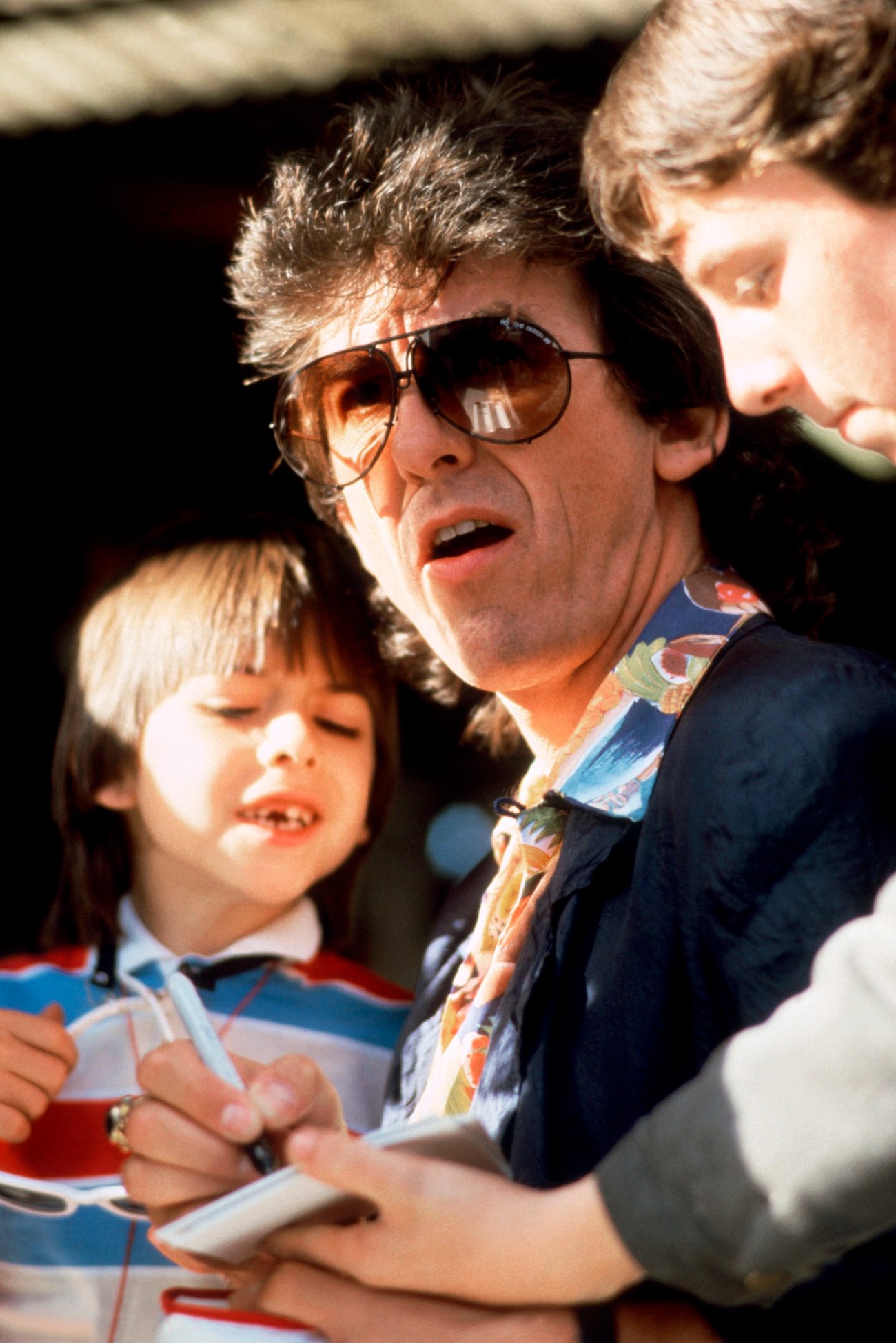 George Harrison and his son Dhani at the Formula One depot in 1985.