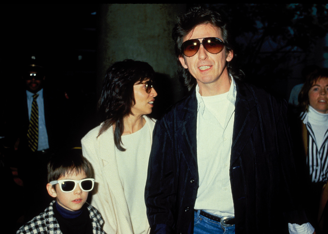 George Harrison with his wife Olivia and their son Dhani at LAX Airport in 1988.