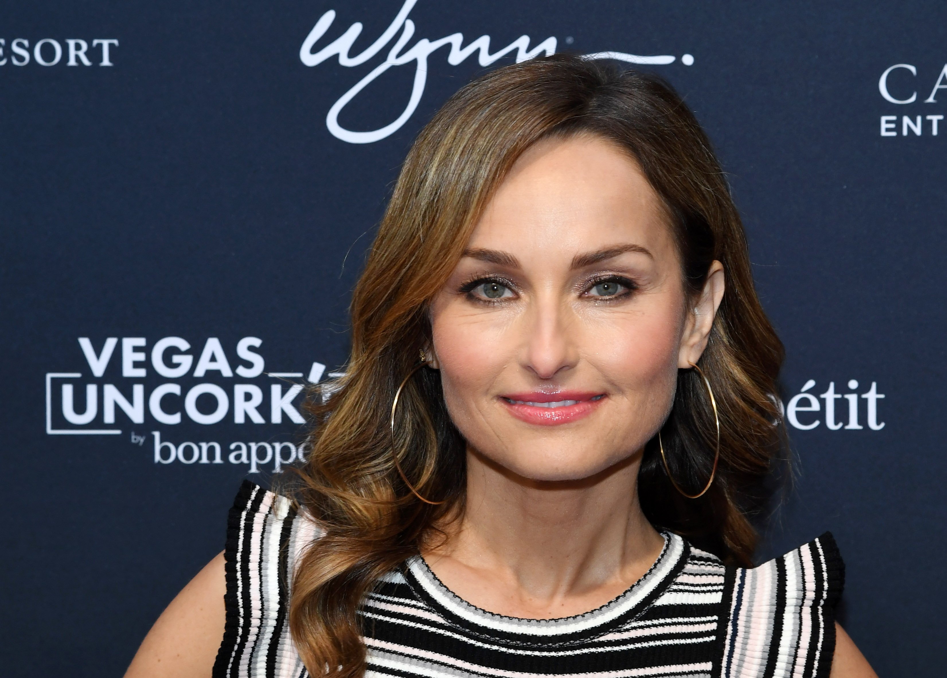 Food Network star Giada De Laurentiis wears a striped sleeveless blouse in this photograph.