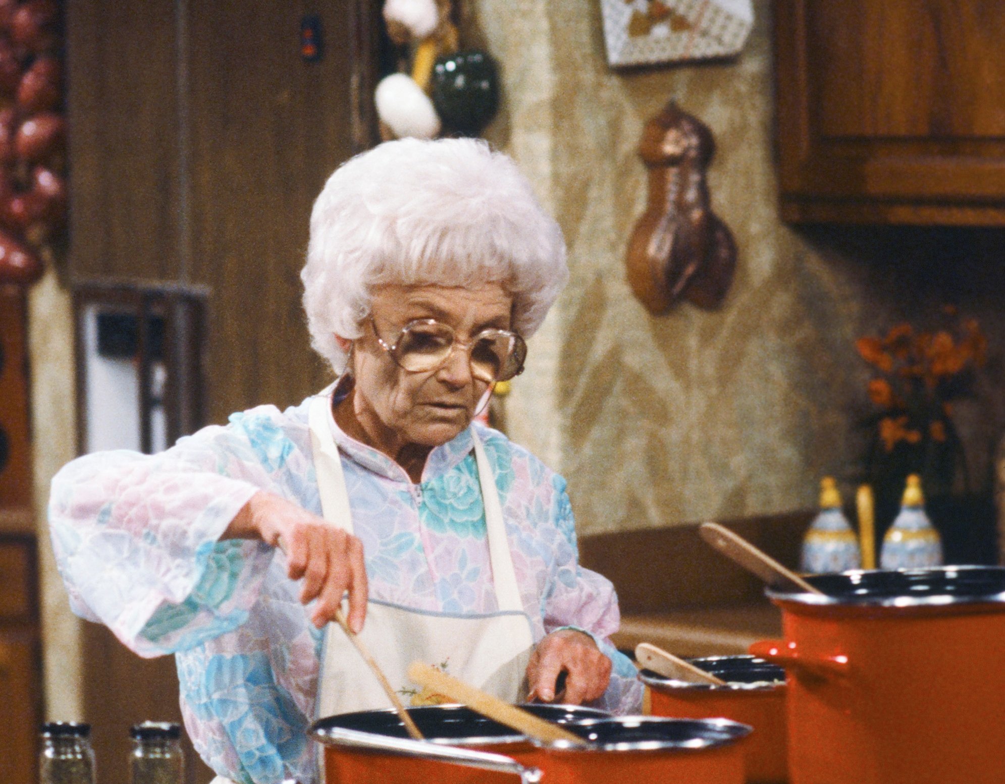 Estelle Getty as Sophia Petrillo stands in the kitchen next to an unidentified kitchen tin in 'The Golden Girls'