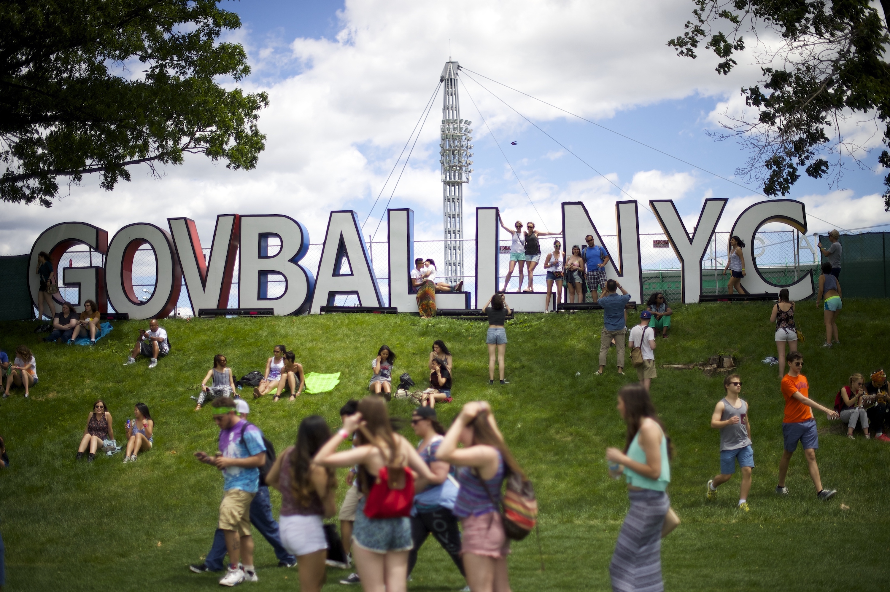 Attendees gather near the hilltop sign of the Governors Ball Music Festival