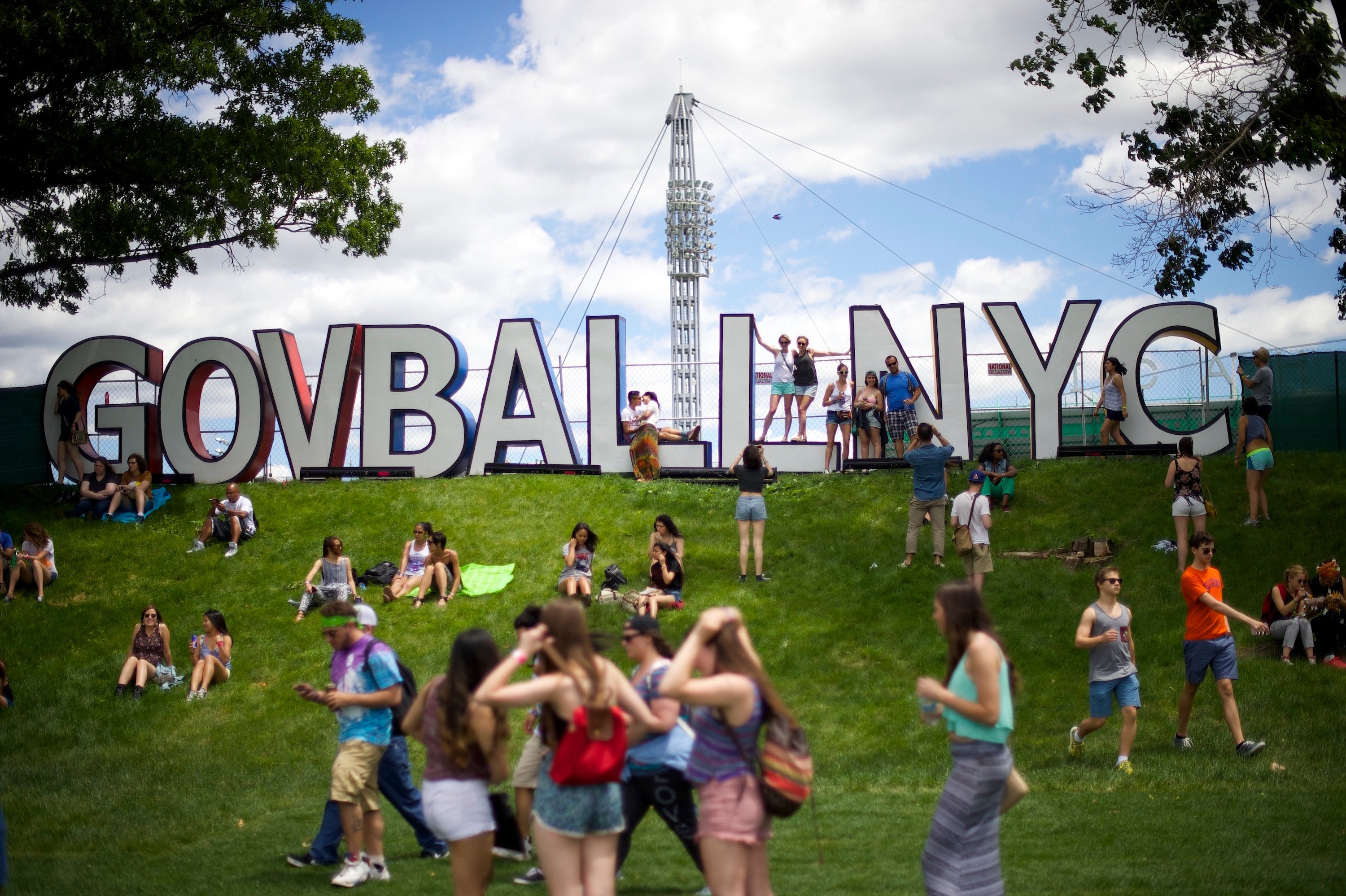 Attendees gather near the hilltop sign of the Governors Ball Music Festival