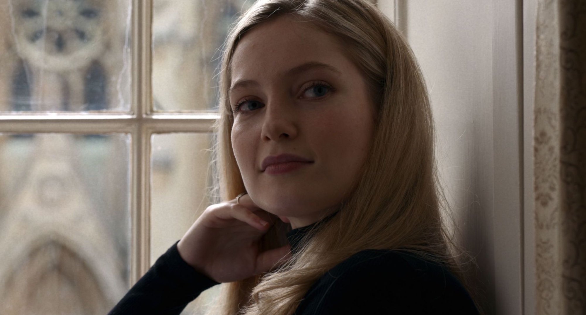 Hannah Dodd from 'Anatomy of a Scandal' cast in 'Bridgerton' Season 3 sitting by window.