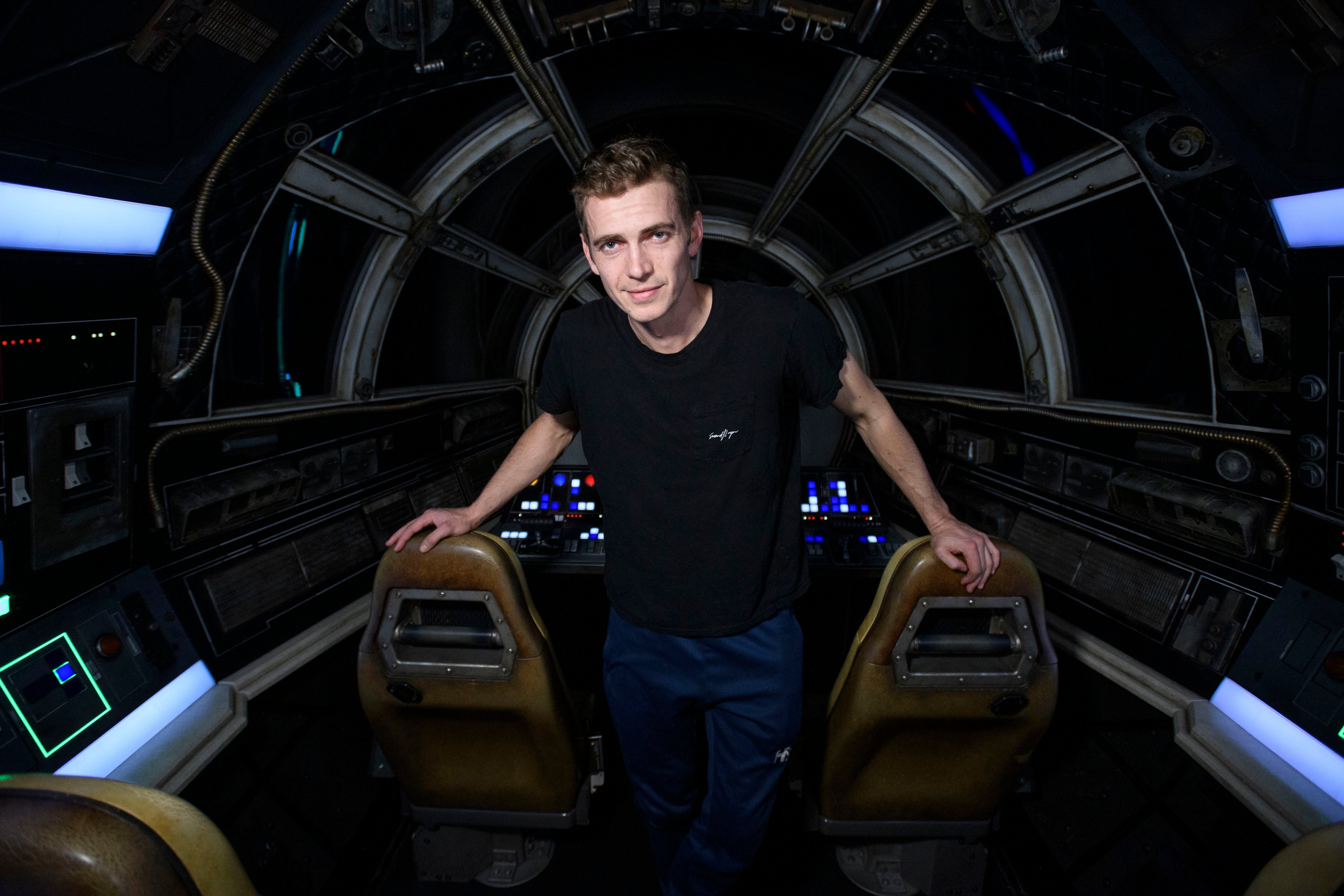 Anakin Skywalker actor Hayden Christensen stands in the cockpit of Millennium Falcon: Smuggler's Run at Star Wars: Galaxy's Edge at Disneyland Resort