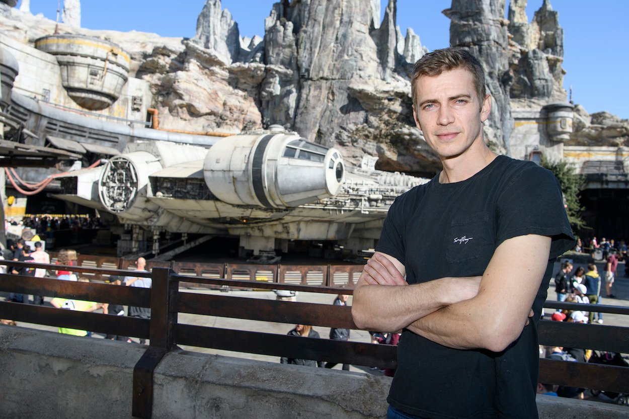 Hayden Christensen poses in front of the Millennium Falcon in Disneyland's Star Wars: Galaxy's Edge attraction. Christensen net worth hits eight figures in part because of 'Star Wars.'