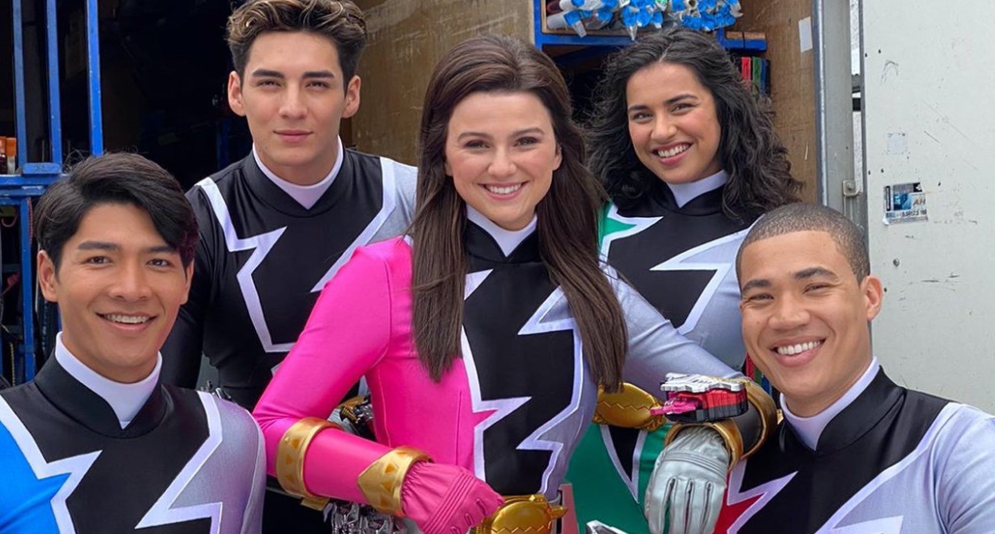Hunter Dino and Tessa Rao with cast of 'Power Rangers Dino Fury' in Ranger suits.