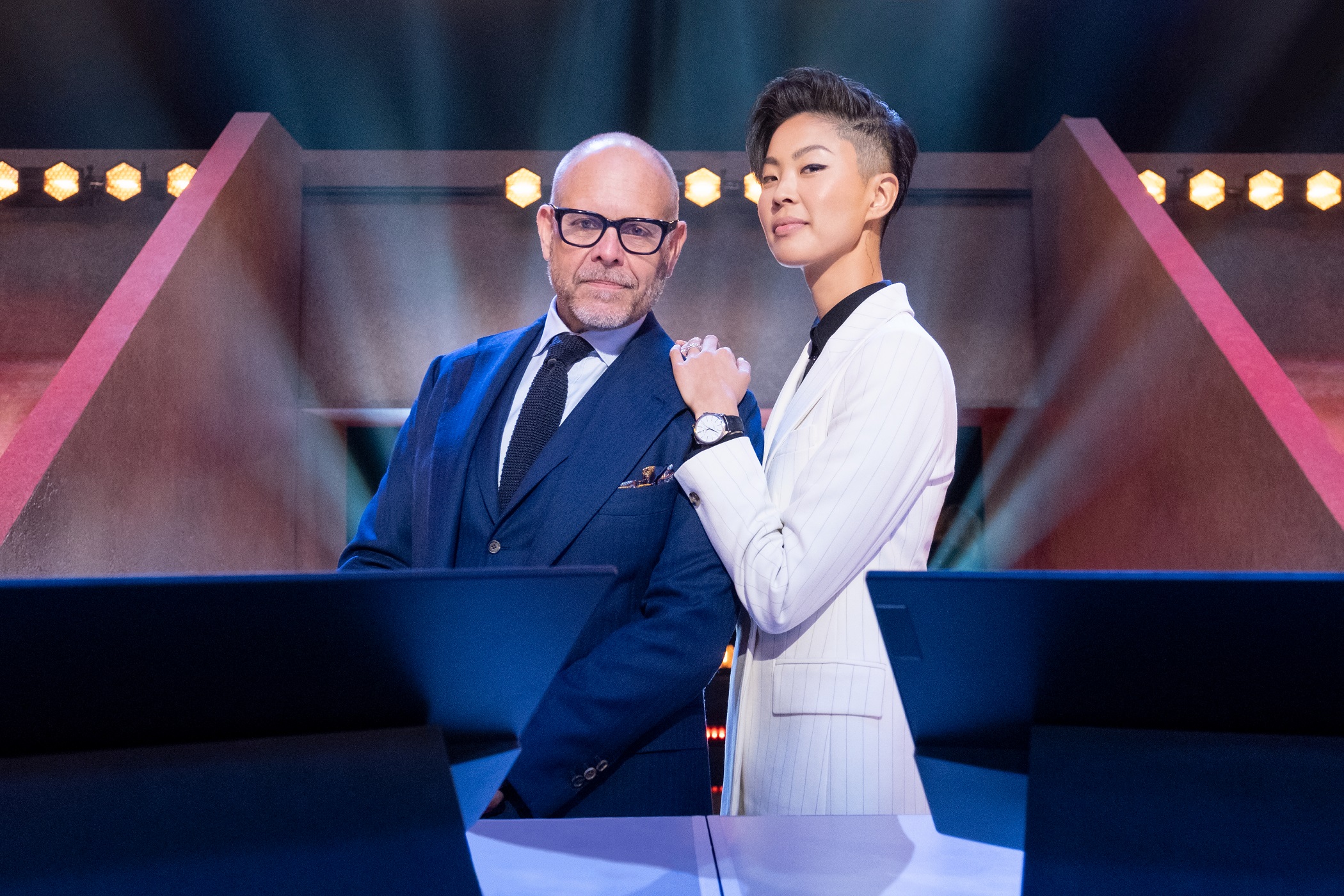 Alton Brown and Kristen Kish pose for a photo in the new kitchen stadium for 'Iron Chef: Quest for an Iron Legend'