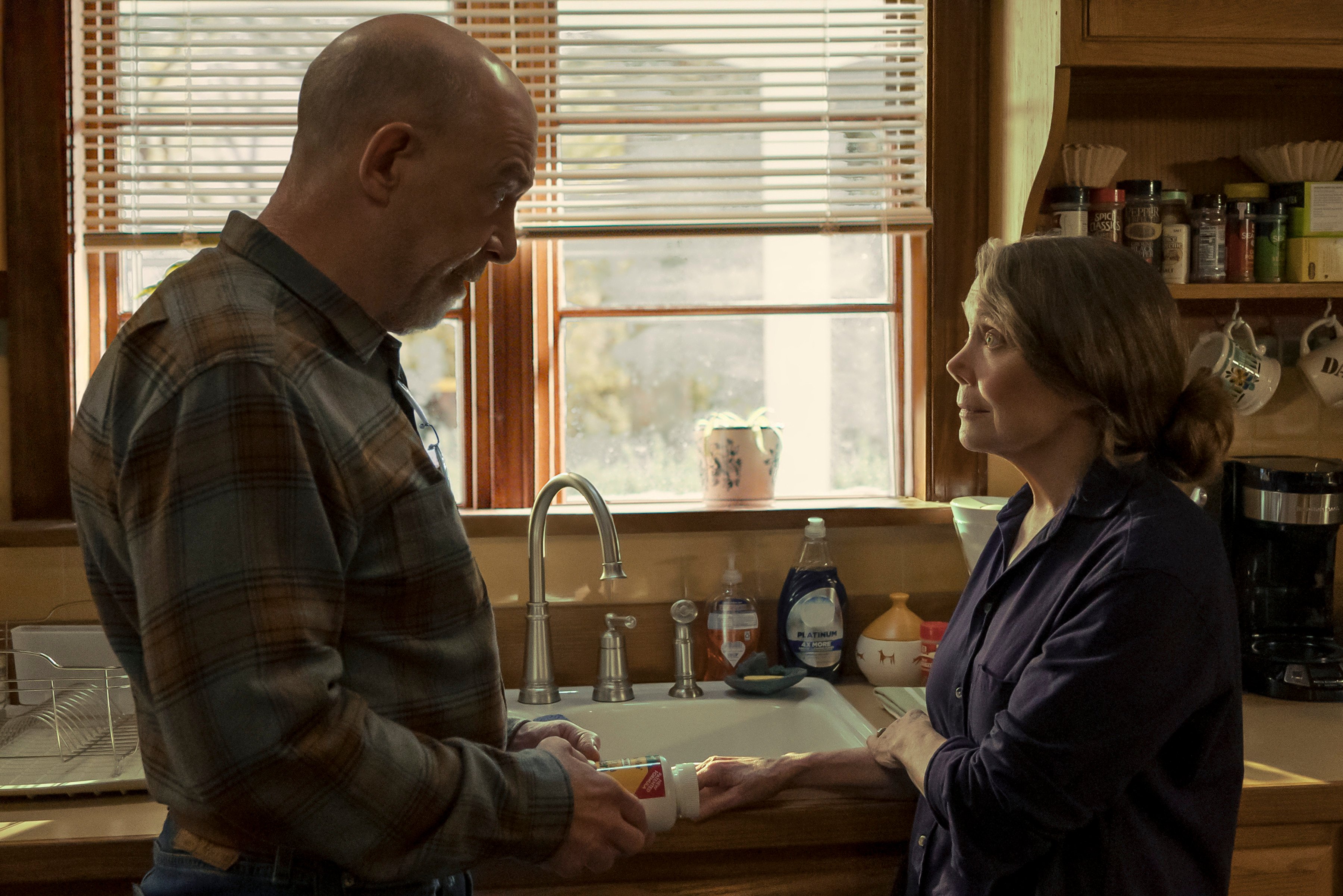 JK Simmons and Sissy Spacek standing in front of a window and looking at each other in Prime Video series 'Night Sky'